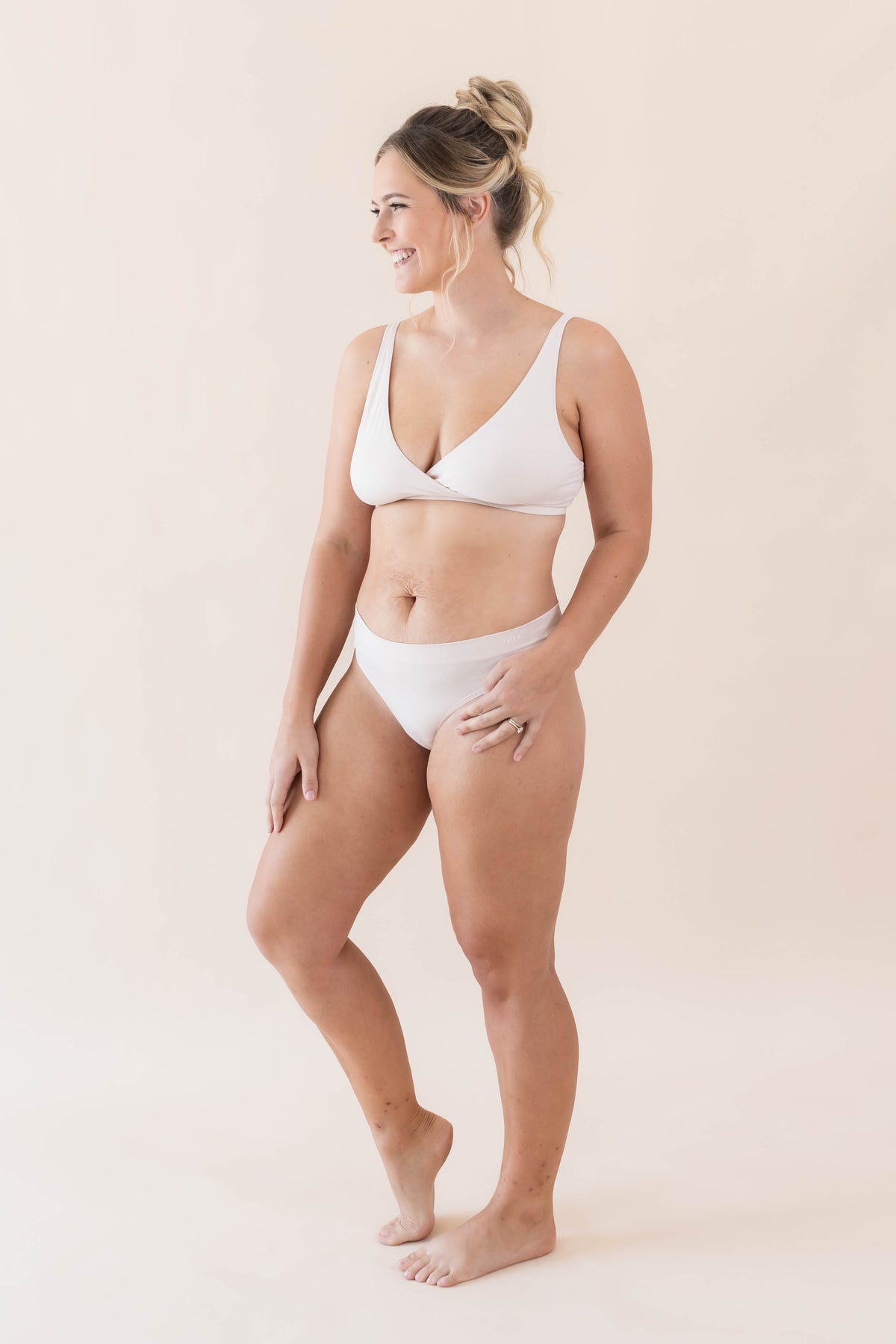 Smiling model wearing the Women's Cross Front Bralette in Blonde and matching cross front bralette