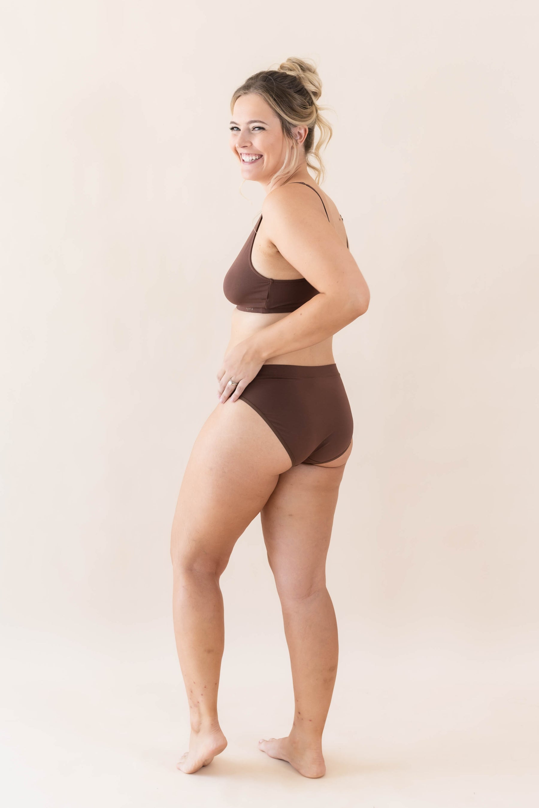 Smiling model posing wearing the Women's Midi Brief in Toffee