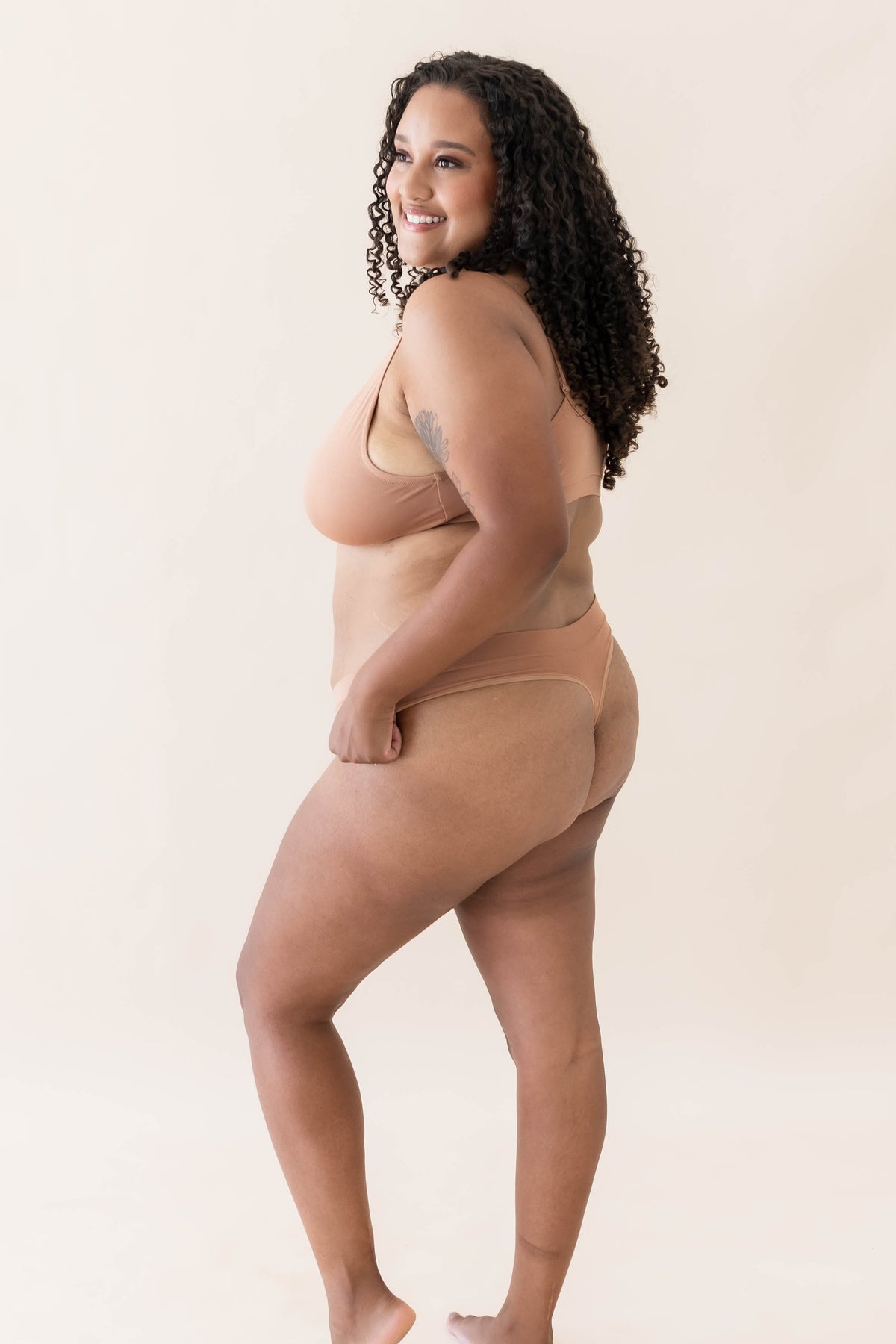 Female modeling the Women's Thong in Latte with matching bralette