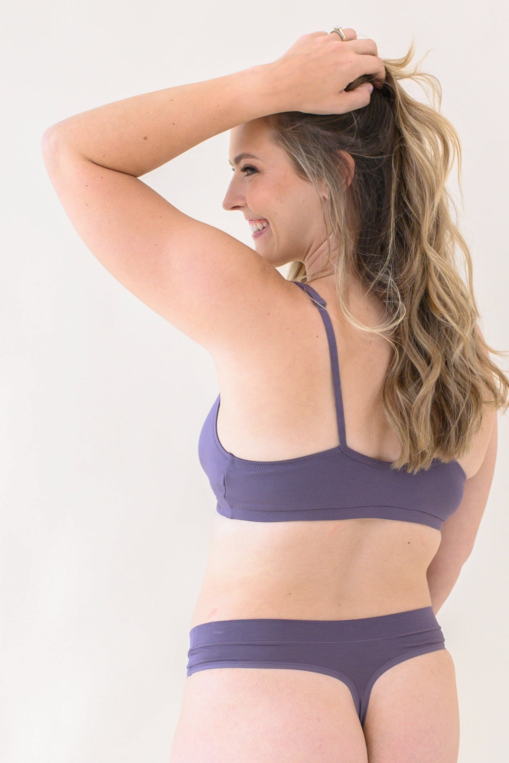 Female modeling the Women's Thong in Currant with matching bralette