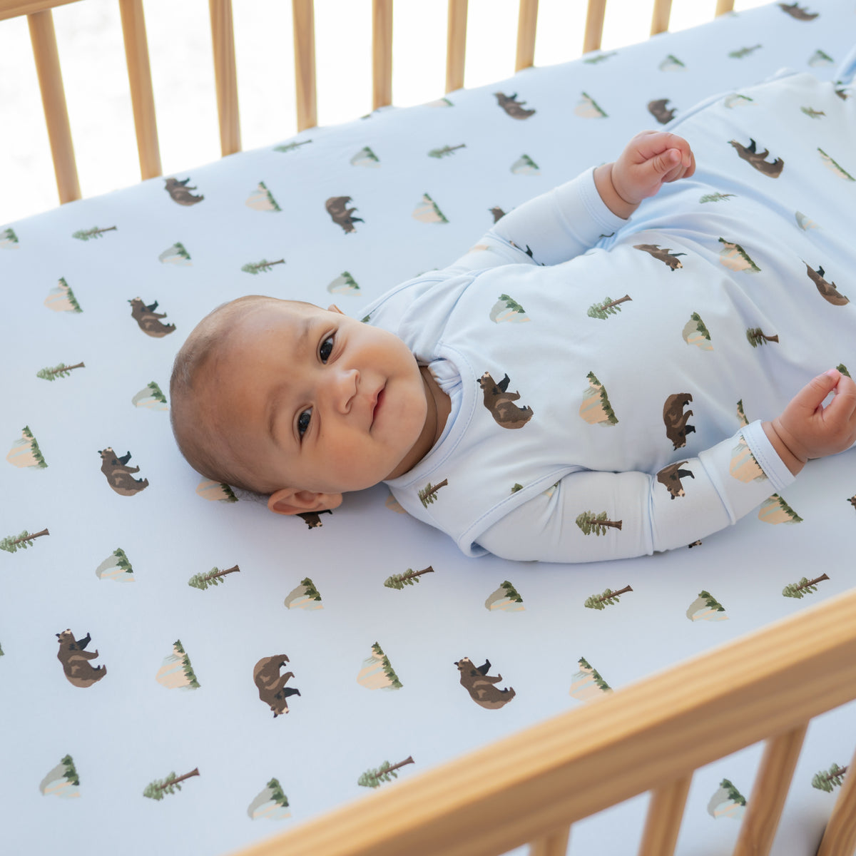 Baby in a crib with a Crib Sheet in Yosemite on wearing a Yosemite Sleep Bag