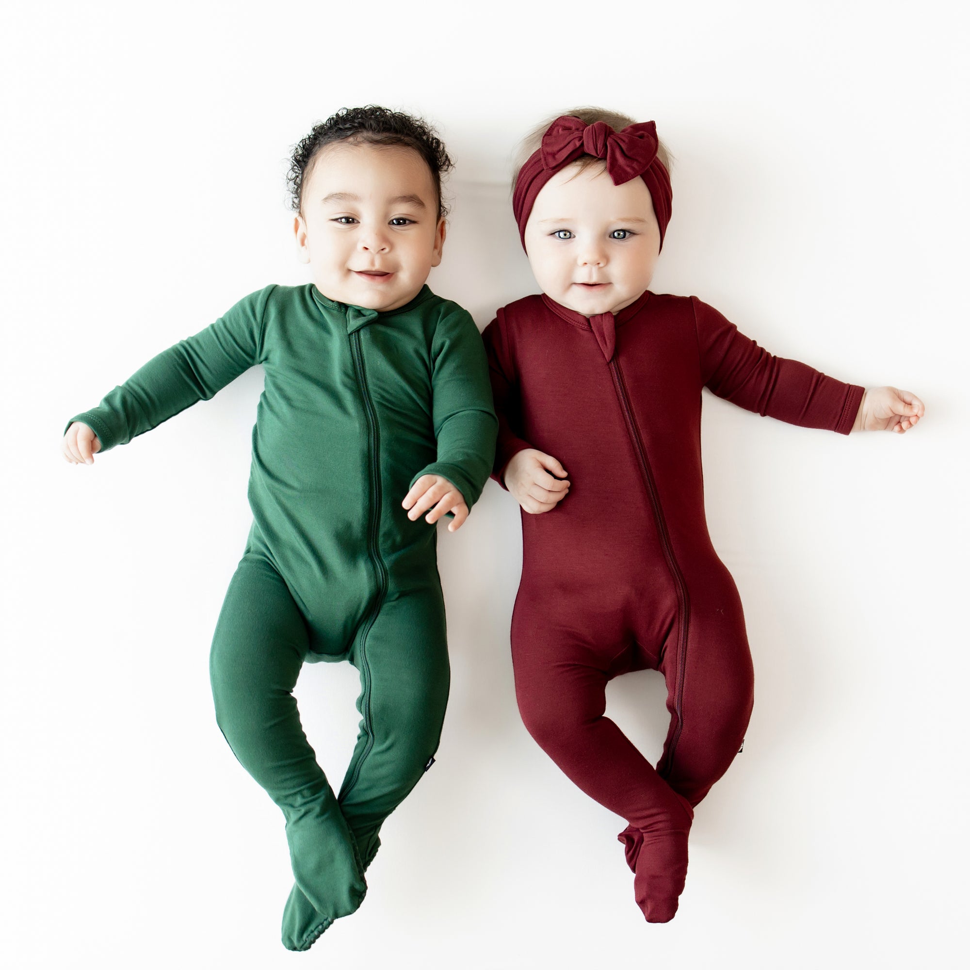 2 babies in zippered footies in evergreen and burgundy  