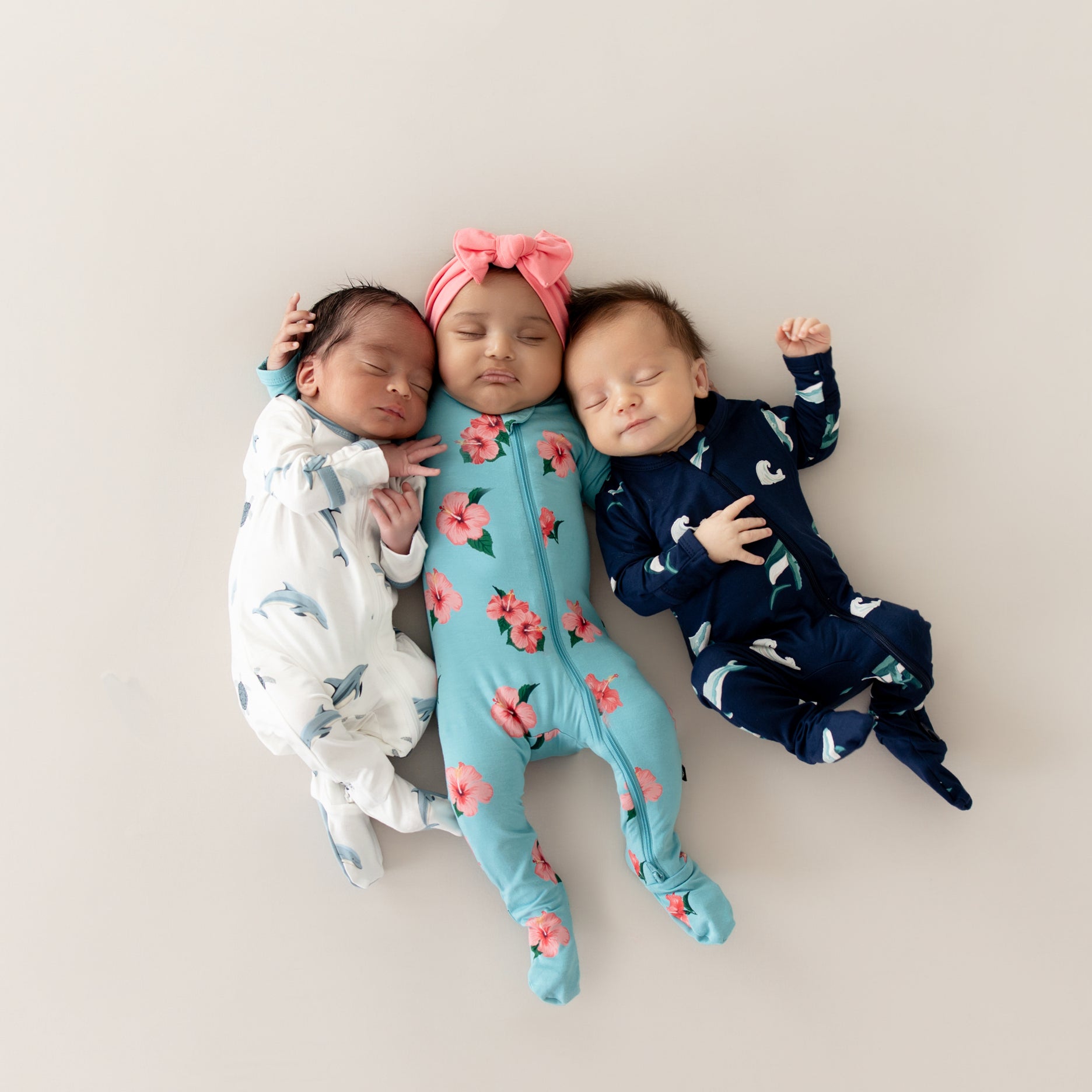 3 babies laying wearing Spring collection from Kyte Baby Zippered Footies