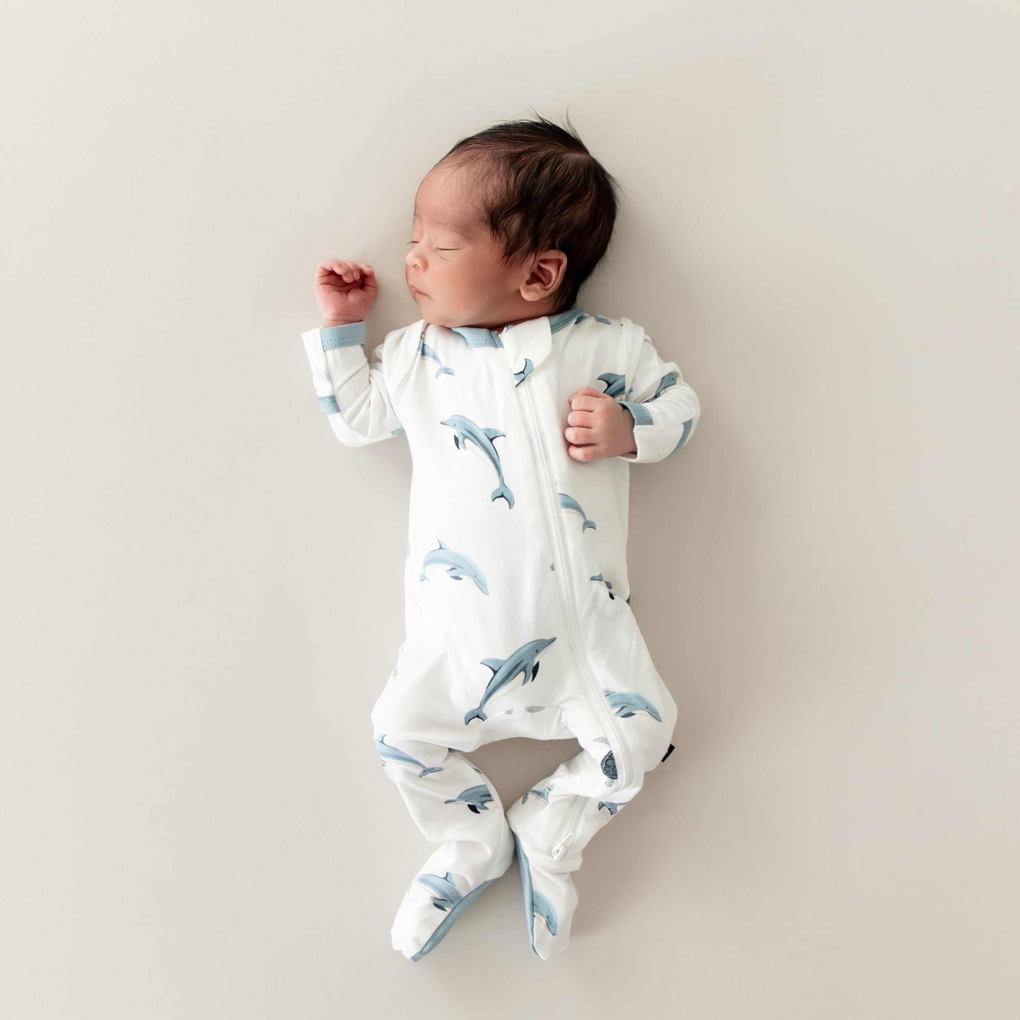 Baby sleeping in Zippered Footie in Dolphin