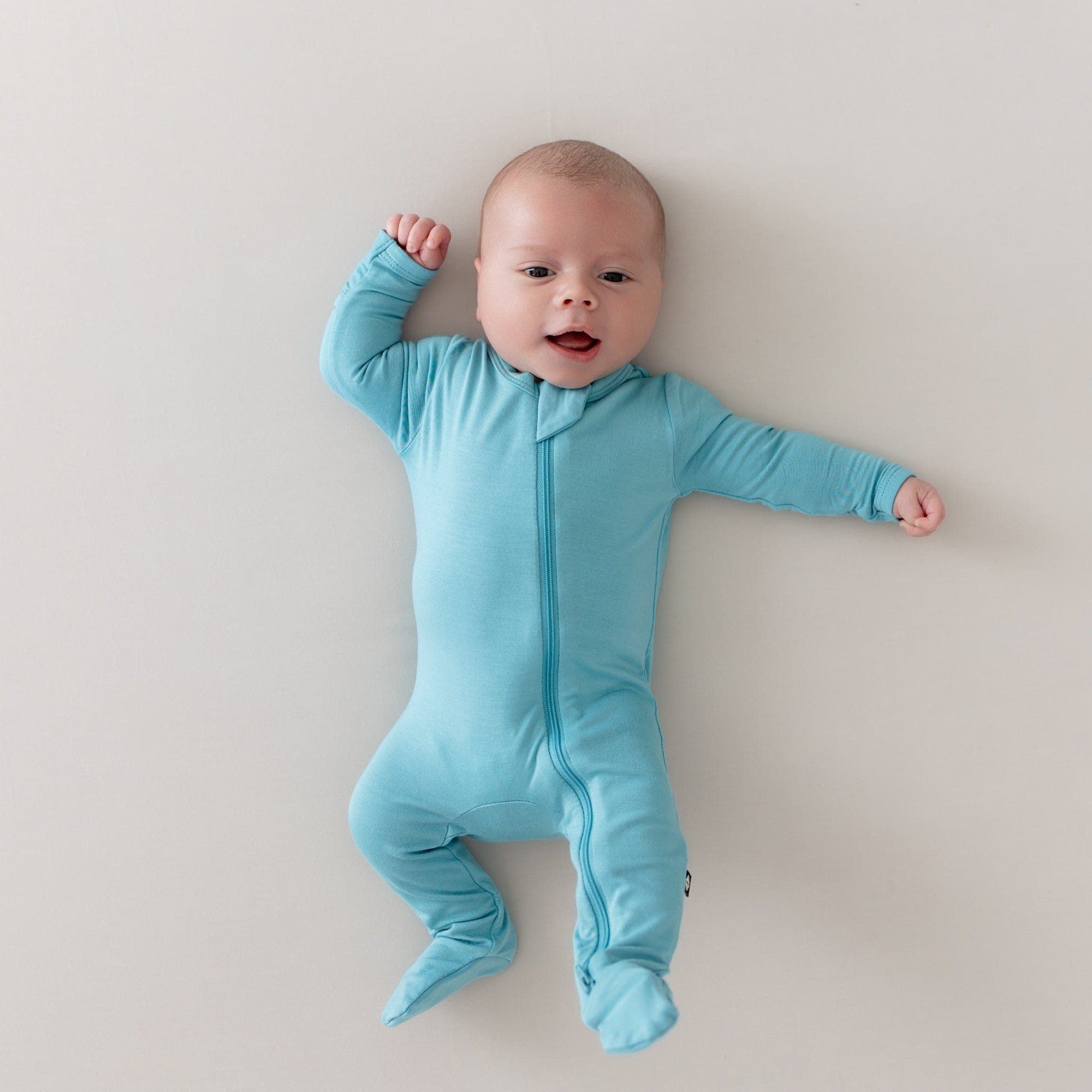 baby yawning and wearing zippered footie in makai 