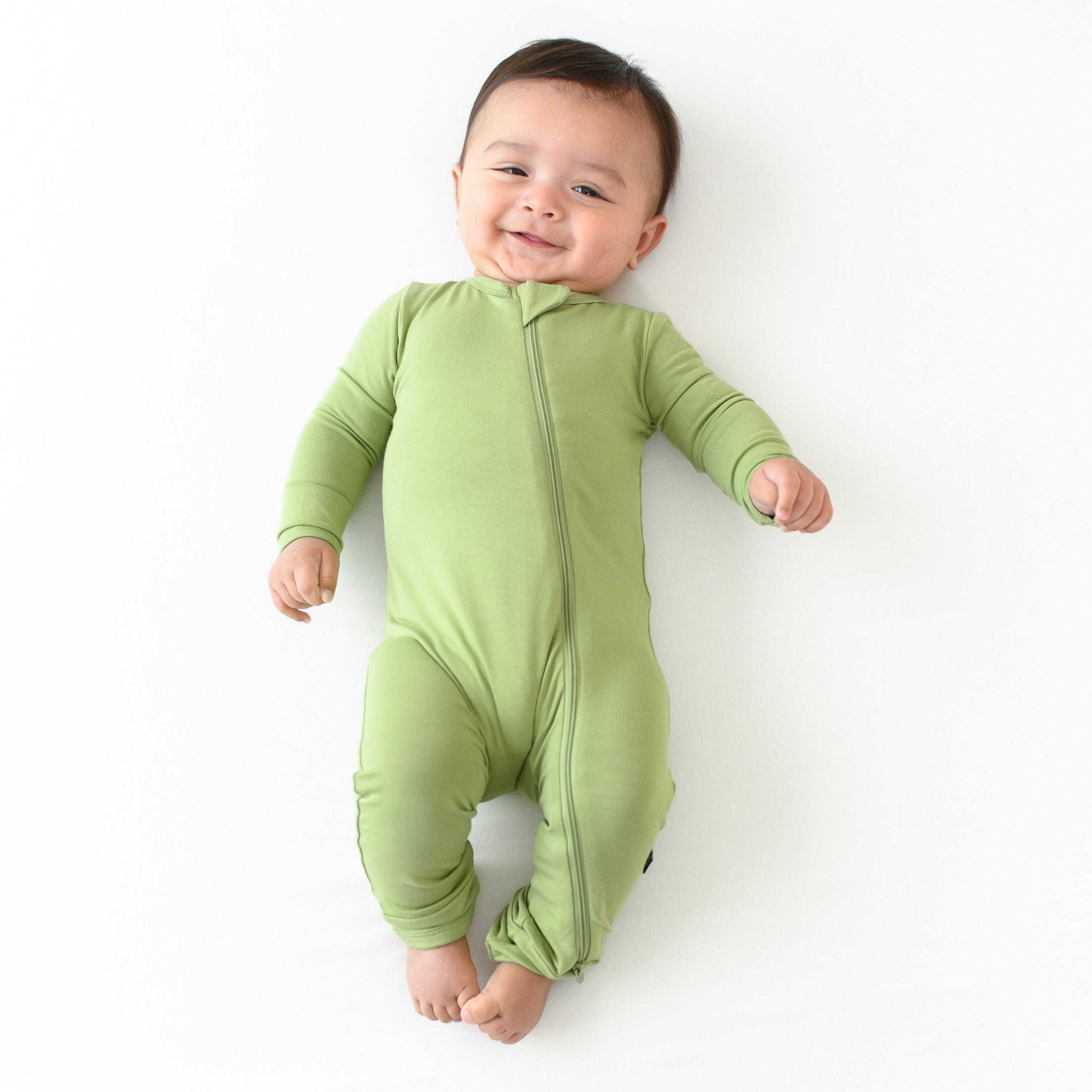 baby wearing zippered romper in honu