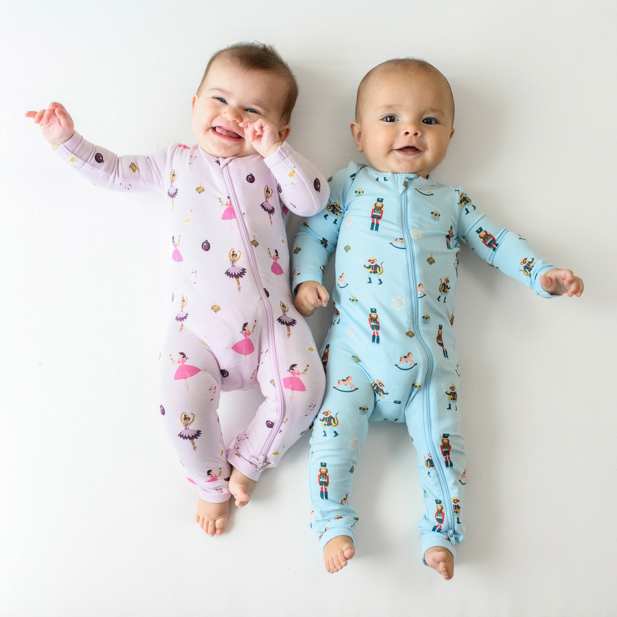 2 babies in zippered rompers in sugar plum and nutcracker