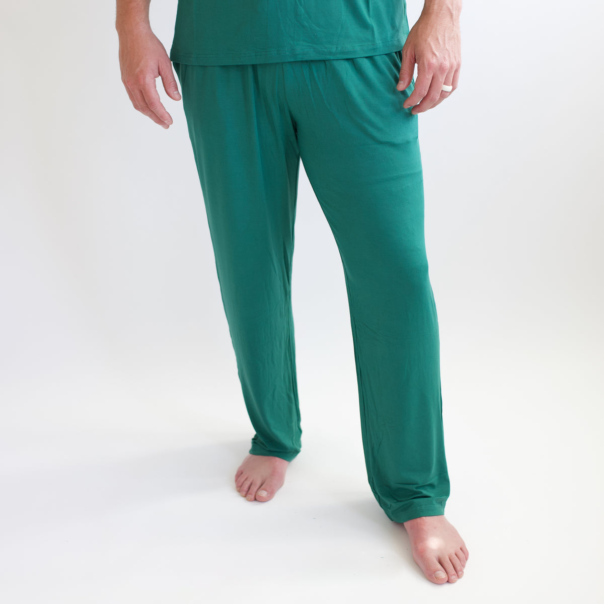 Men's Lounge Pants in Emerald shown on a male model standing in front of a white backdrop