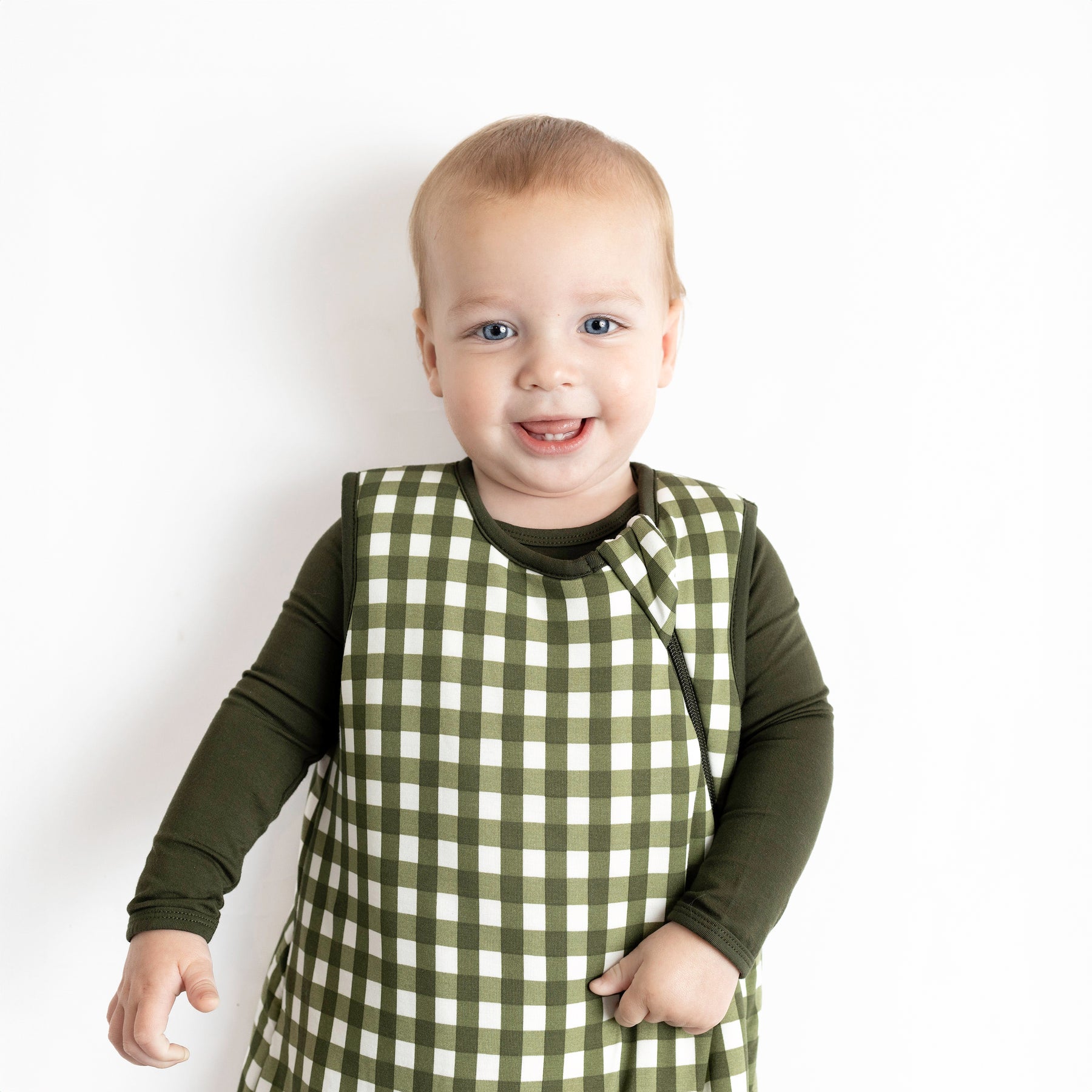 Toddler wearing Sleep Bag in Gingham Fir 2.5 TOG with dark green long sleeve pajamas