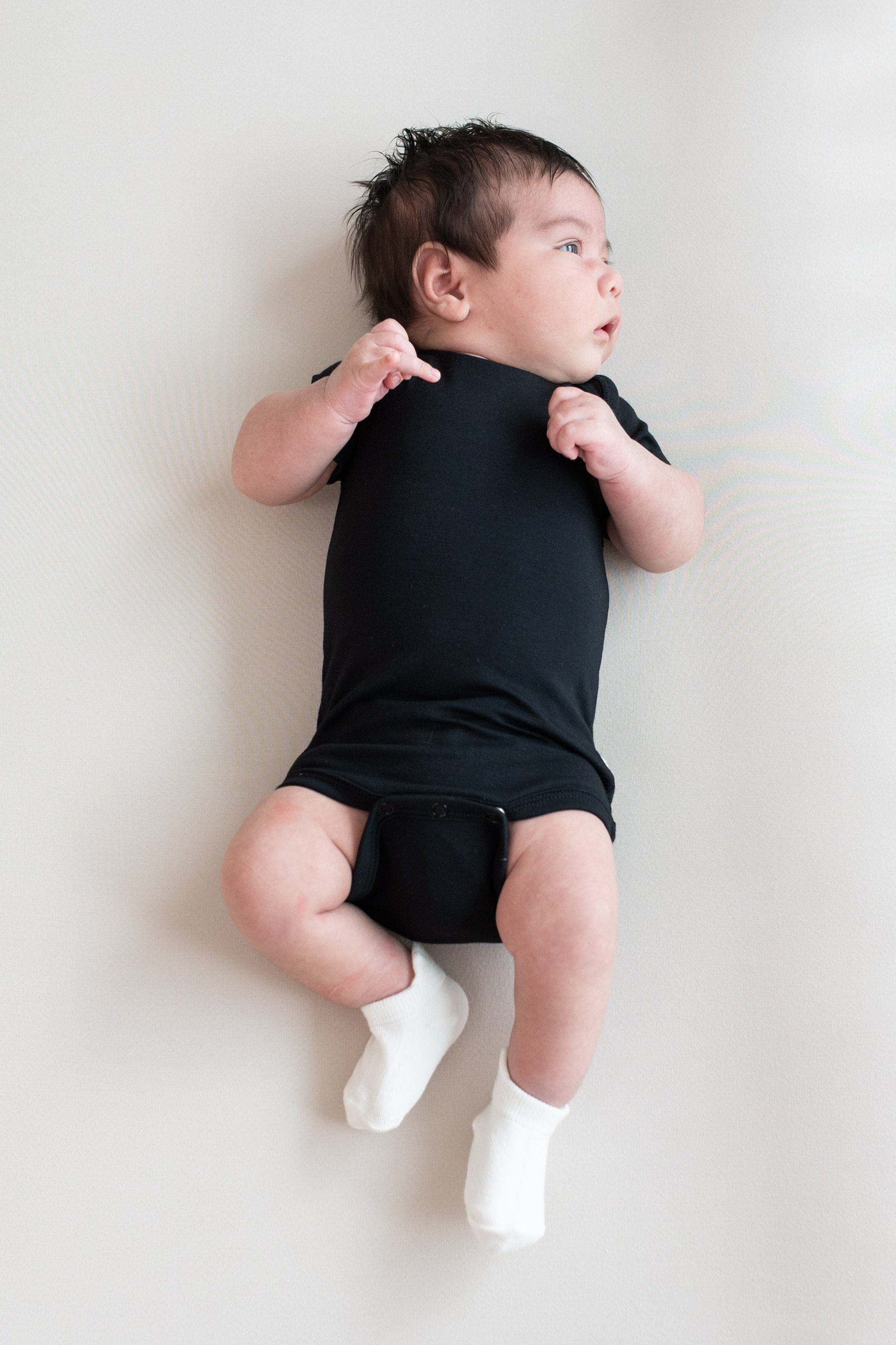 Infant wearing Kyte Baby Ankle Socks in Neutral white