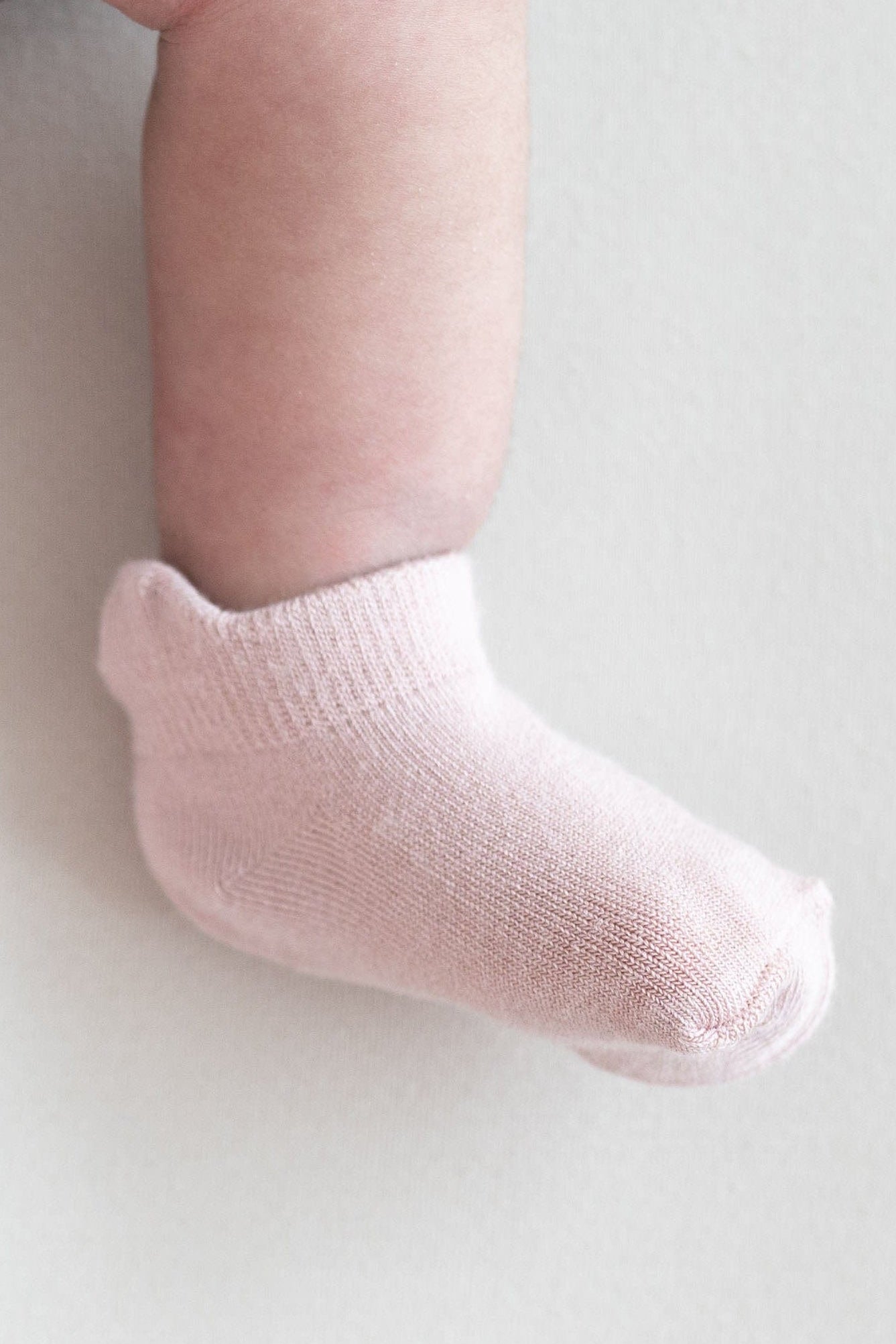 Baby wearing pink ankle socks