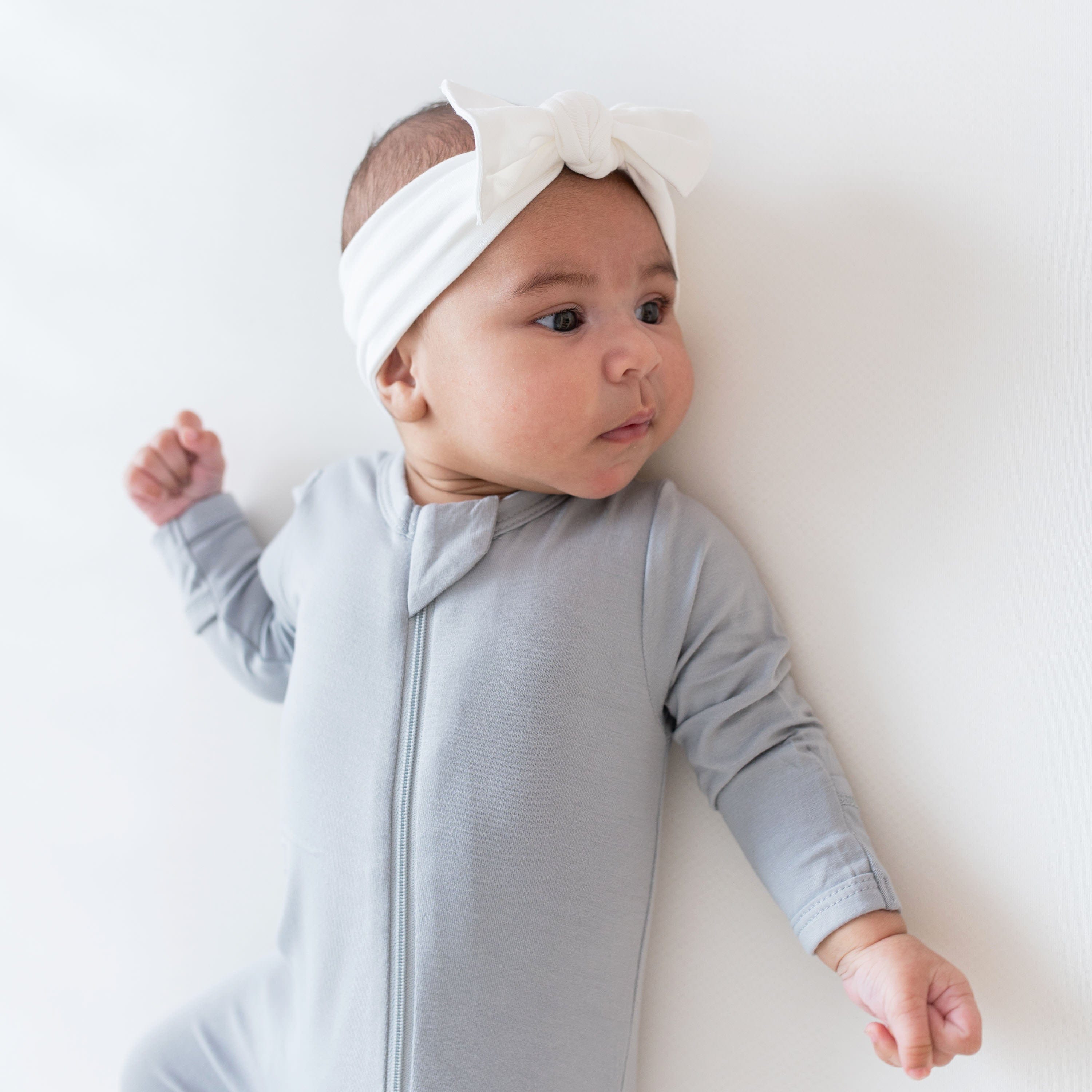 Infant wearing Kyte Baby Bow in Cloud