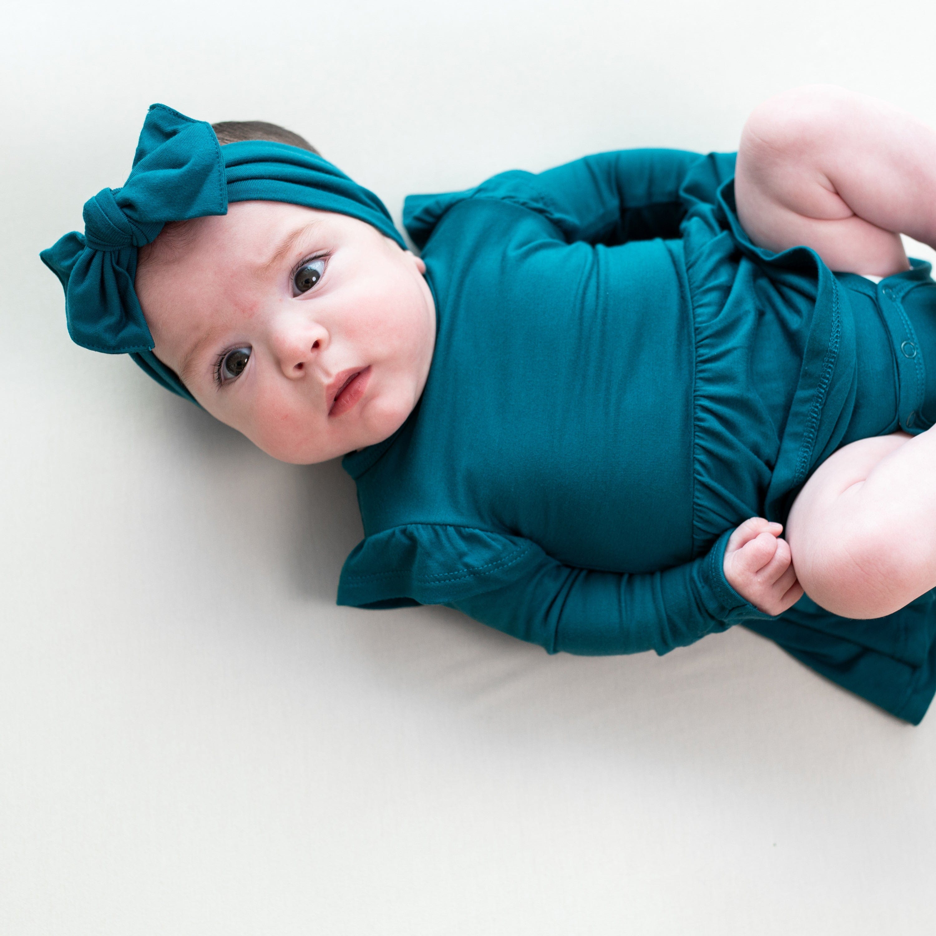 Child wearing Kyte Baby Bodysuit with Twirl Skirt in Loch