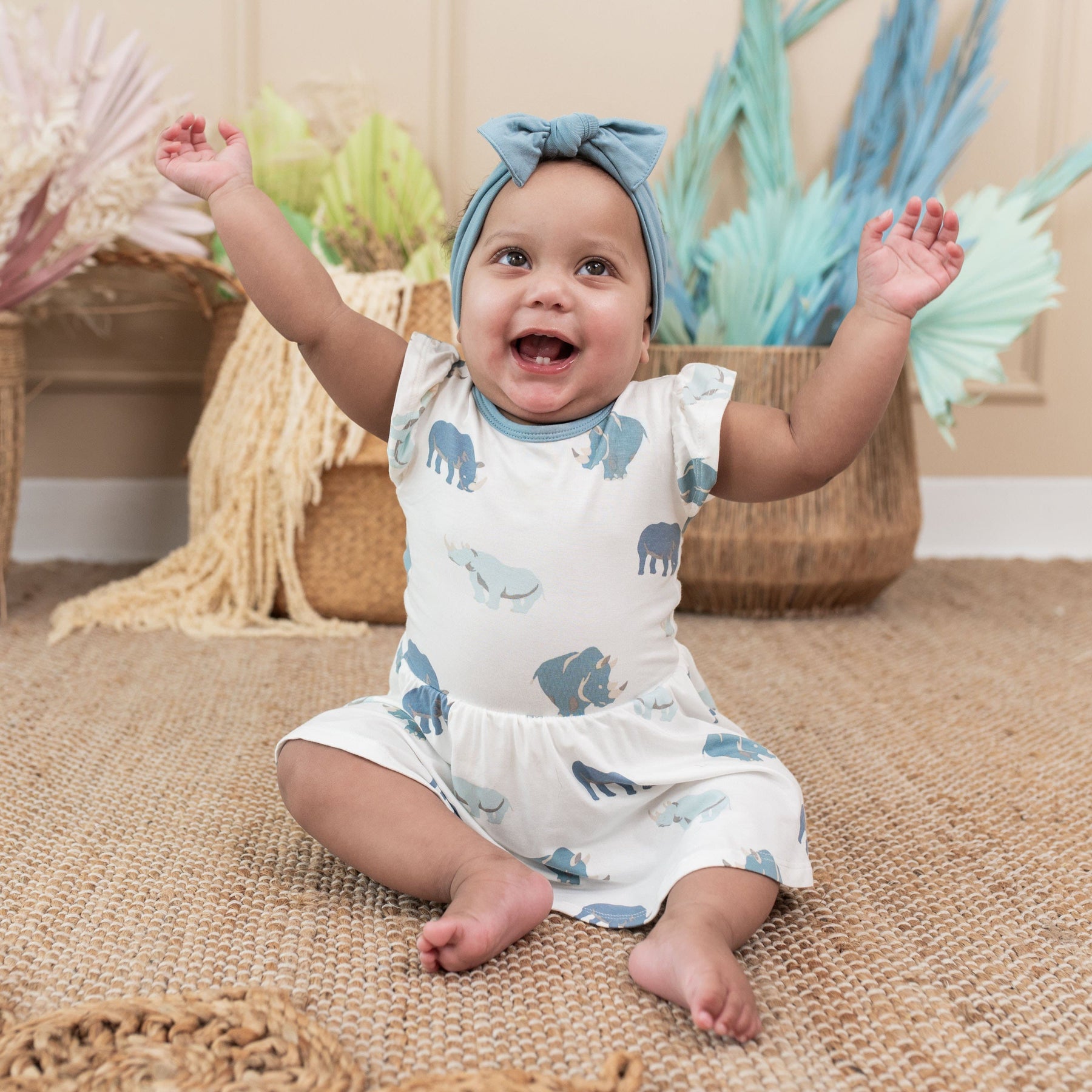 Infant wearing Kyte Baby Twirl Bodysuit in Rhino