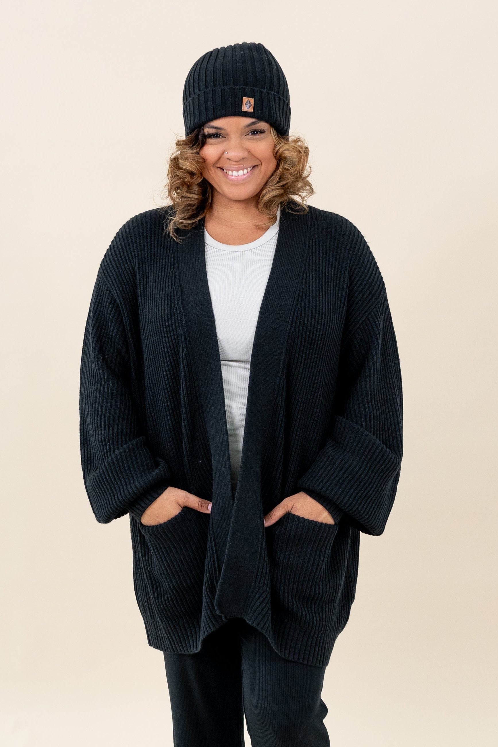 Woman wearing Kyte Baby Chunky Knit Women's Oversized Cardigan in Midnight