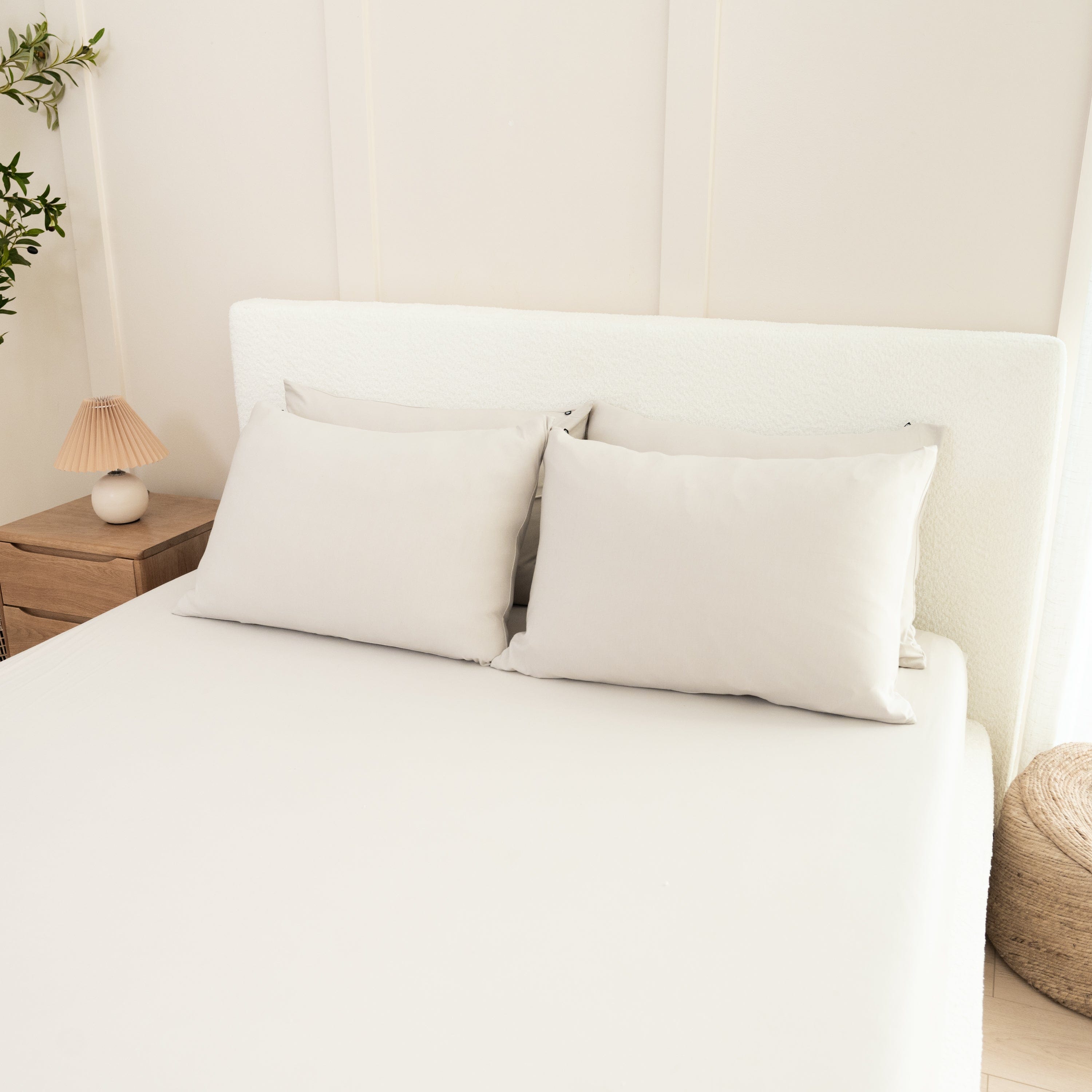 Bed Made with Kyte Baby Fitted Sheet with Pillowcases in Oat