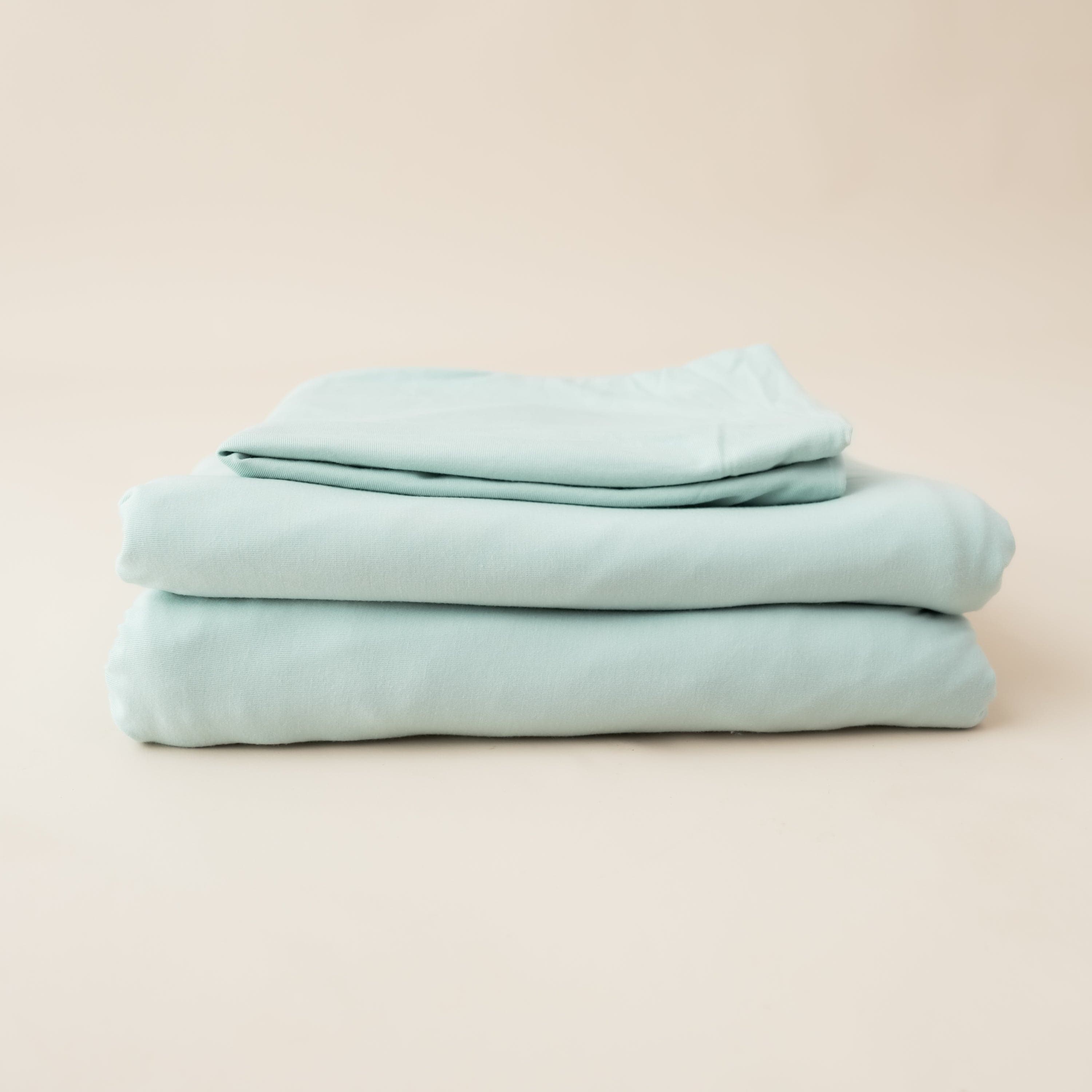 Folded Kyte Baby Fitted Sheet with Pillowcases in Sage