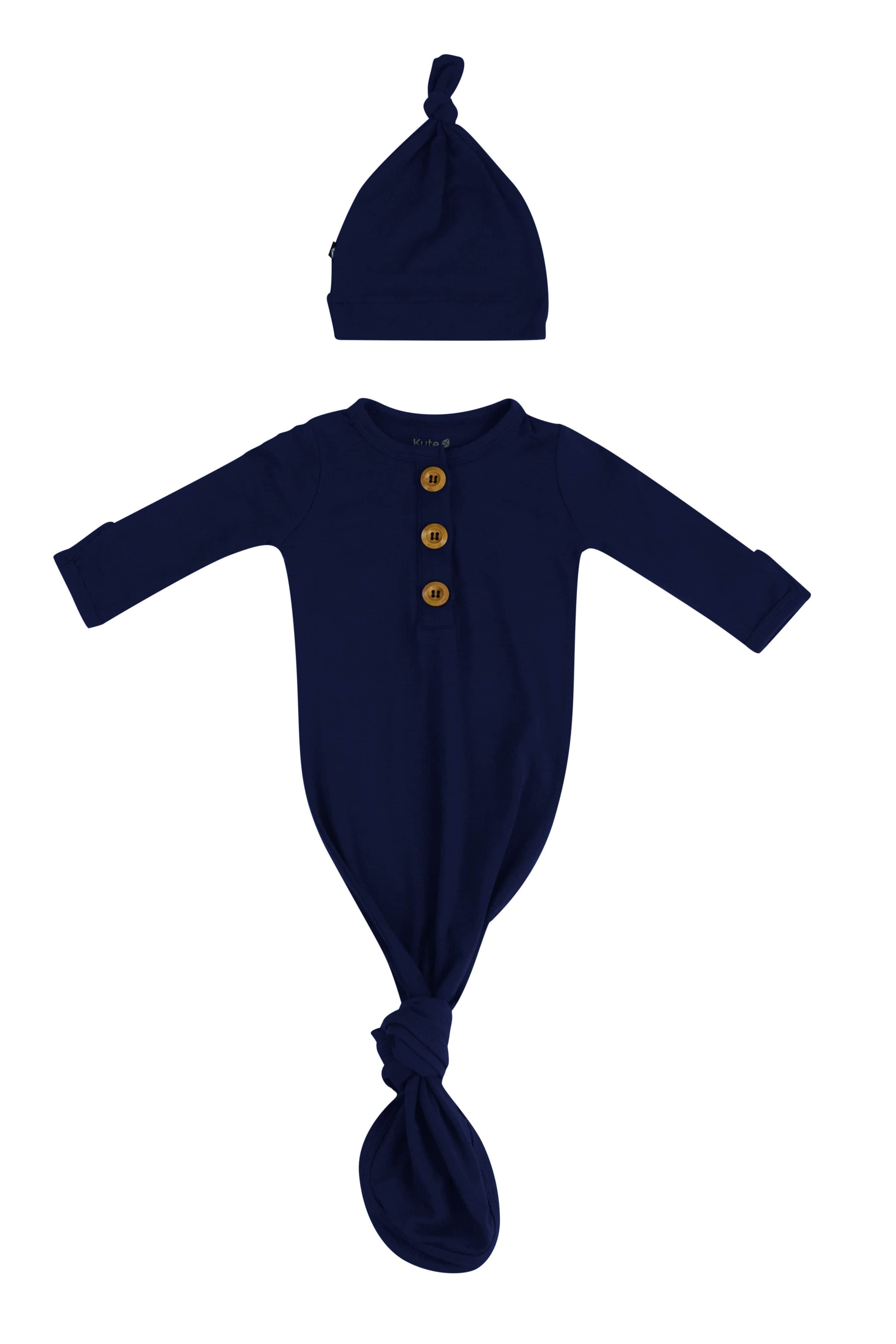 Flat lay of Kyte Baby Knotted Gown with Hat Set in Navy