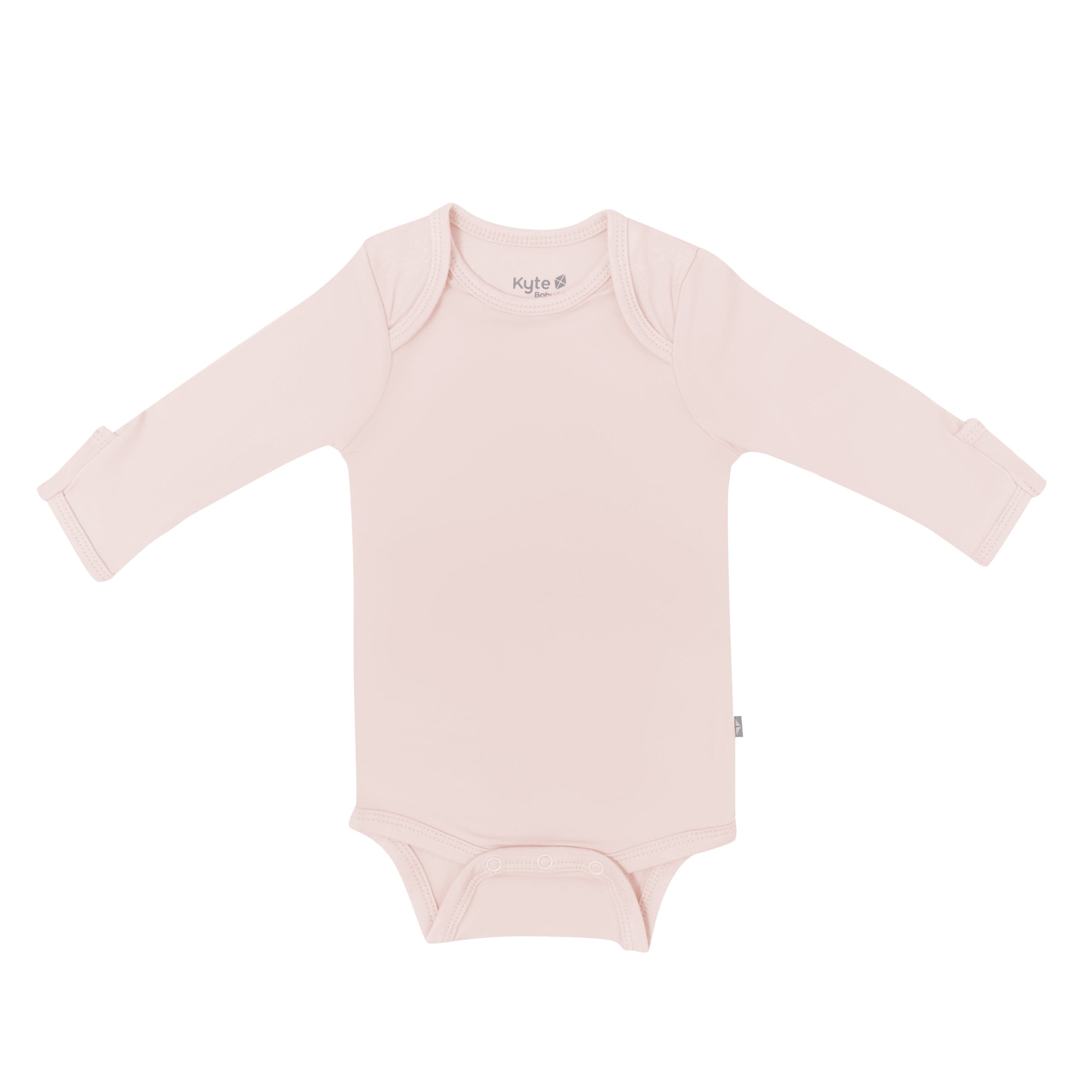 Flat lay of Kyte Baby Long Sleeve Bodysuit in  Blush