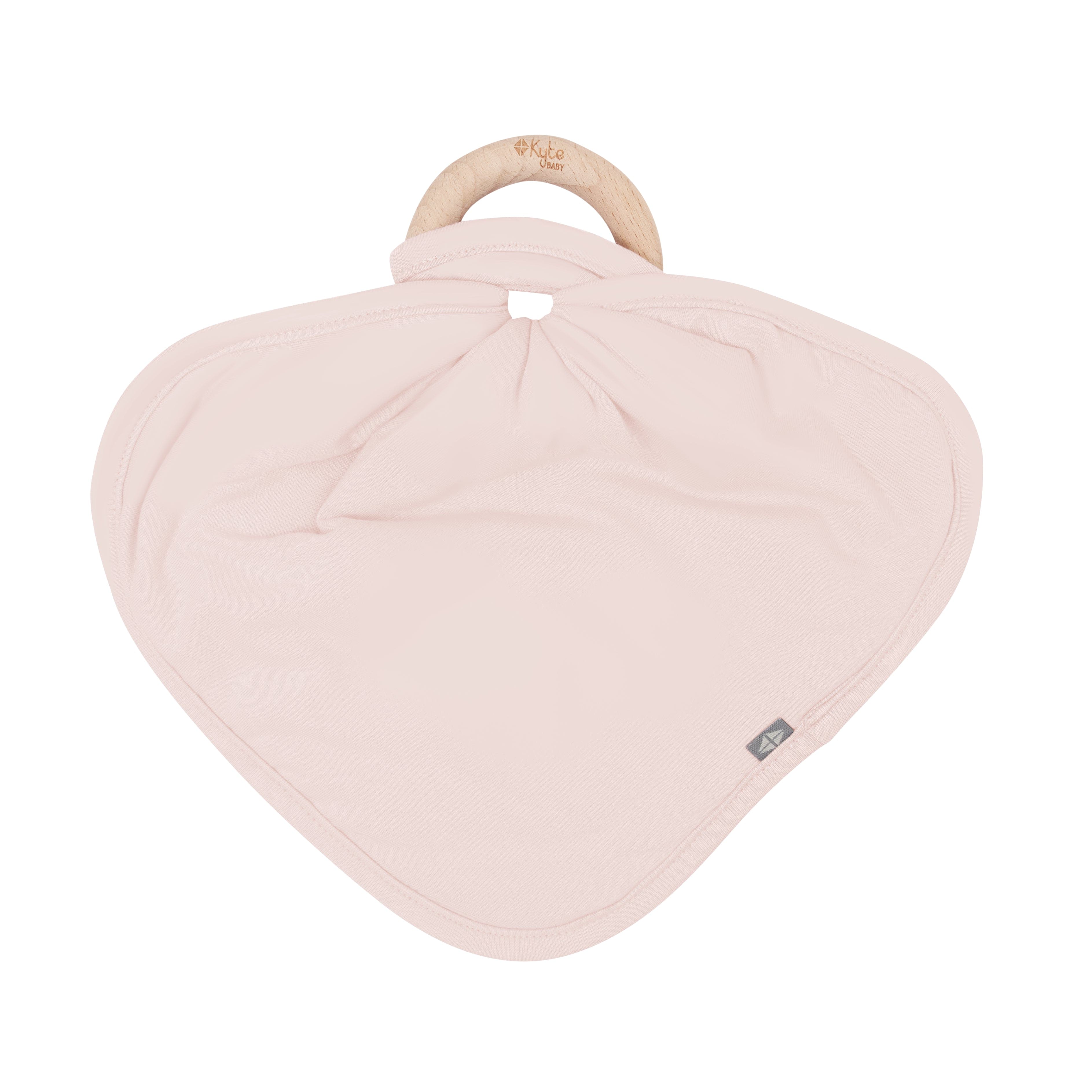 Flat lay of Kyte Baby Lovey in Blush with Removable Wooden Teething Ring