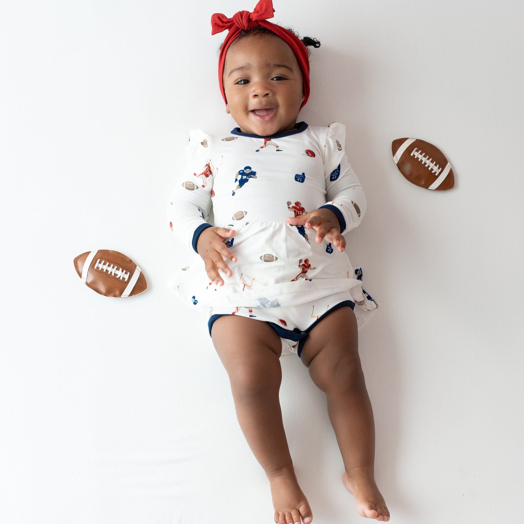 Kyte Baby LS Twirl Bodysuit Dress Long Sleeve Twirl Bodysuit Dress in Football