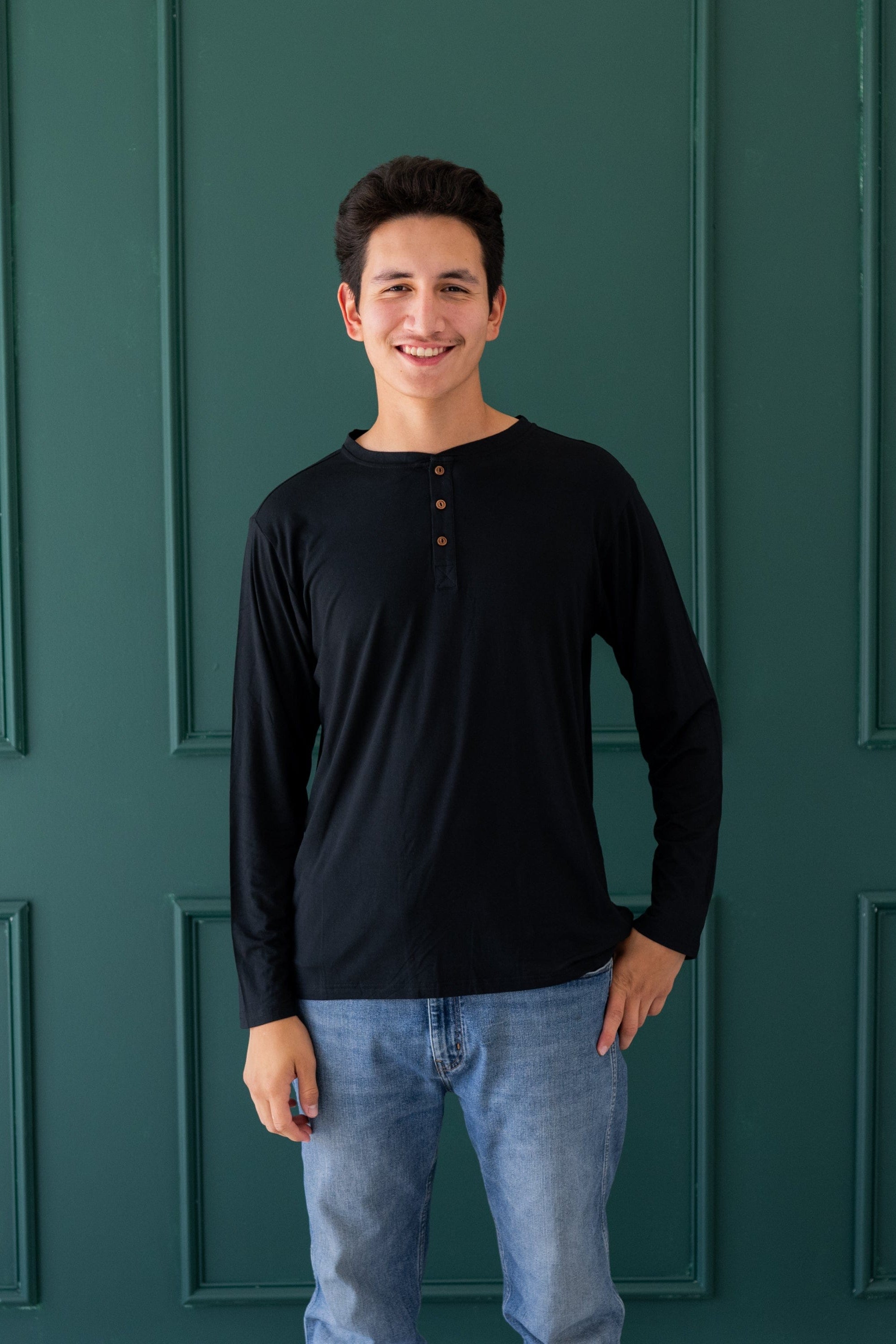 Man wearing Kyte Baby Men's Long Sleeve Henley Top in Midnight