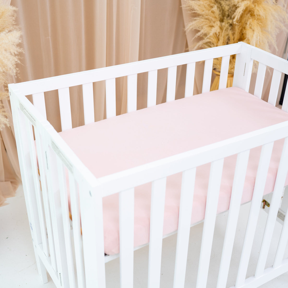 Nursery with Kyte Baby bamboo Mini Crib Sheet in Blush Pink