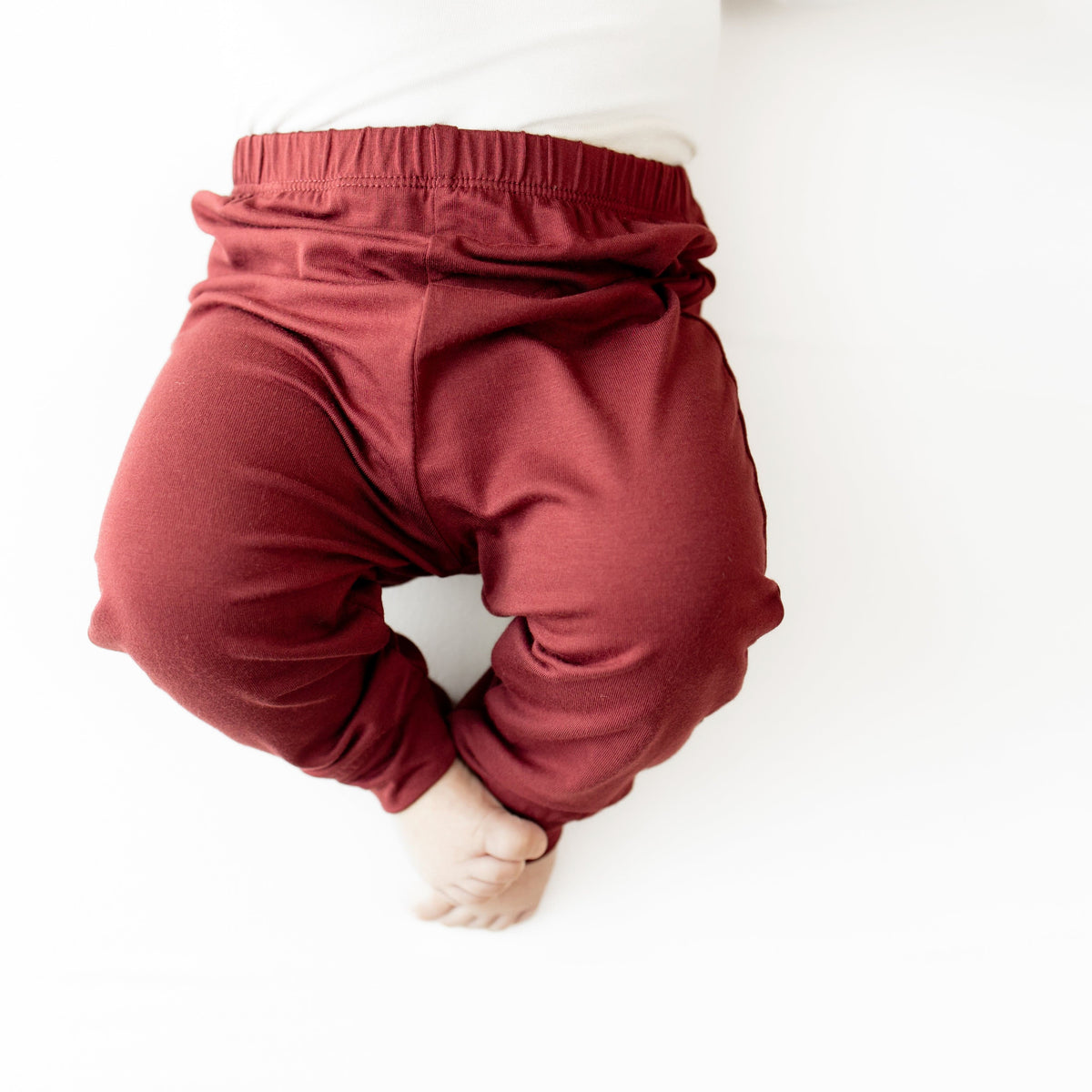 Close up of the Pant in Burgundy on a baby model