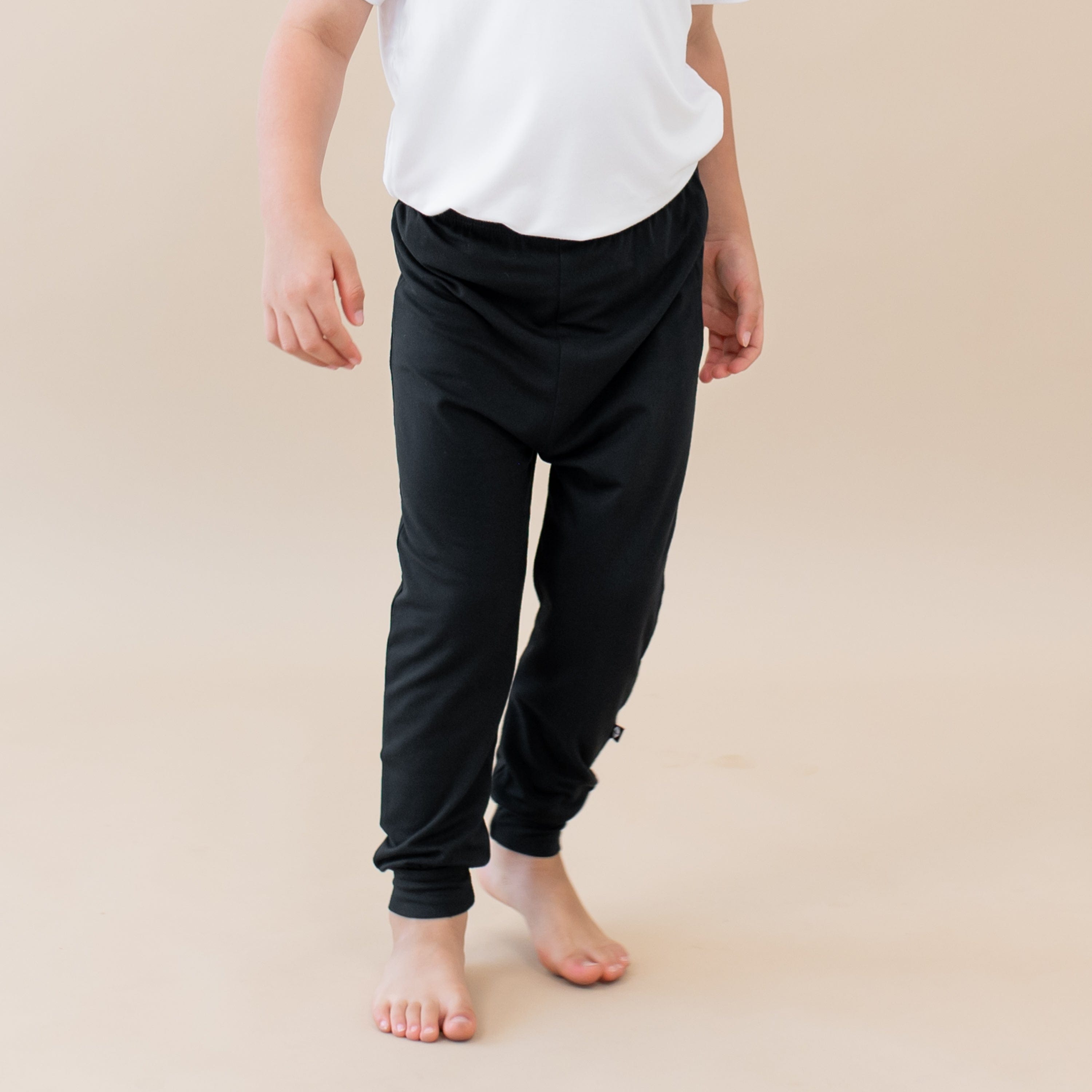 Standing toddler with focus on Kyte Baby Pants in Midnight