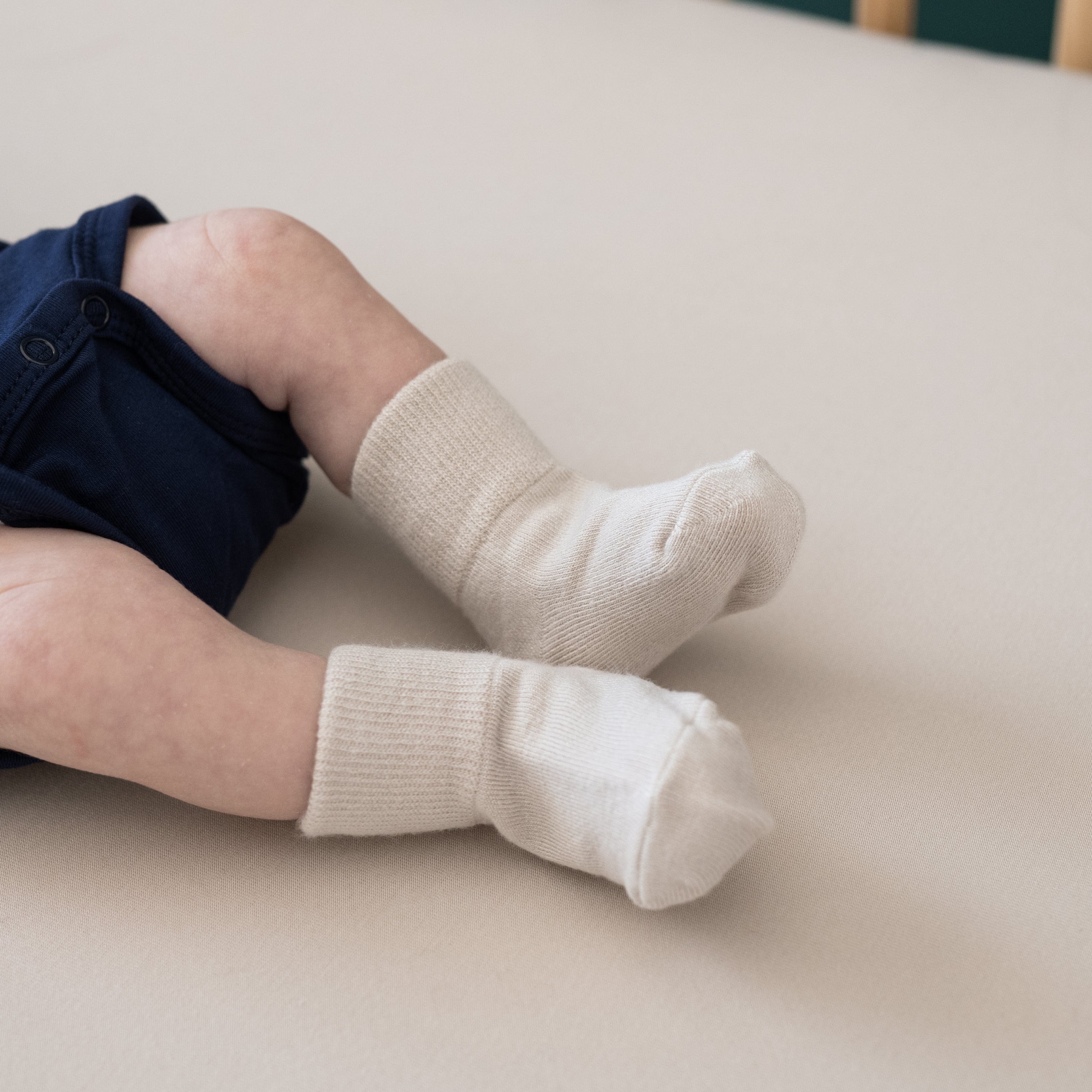 Newborn wearing Kyte Baby Quarter Length Socks
