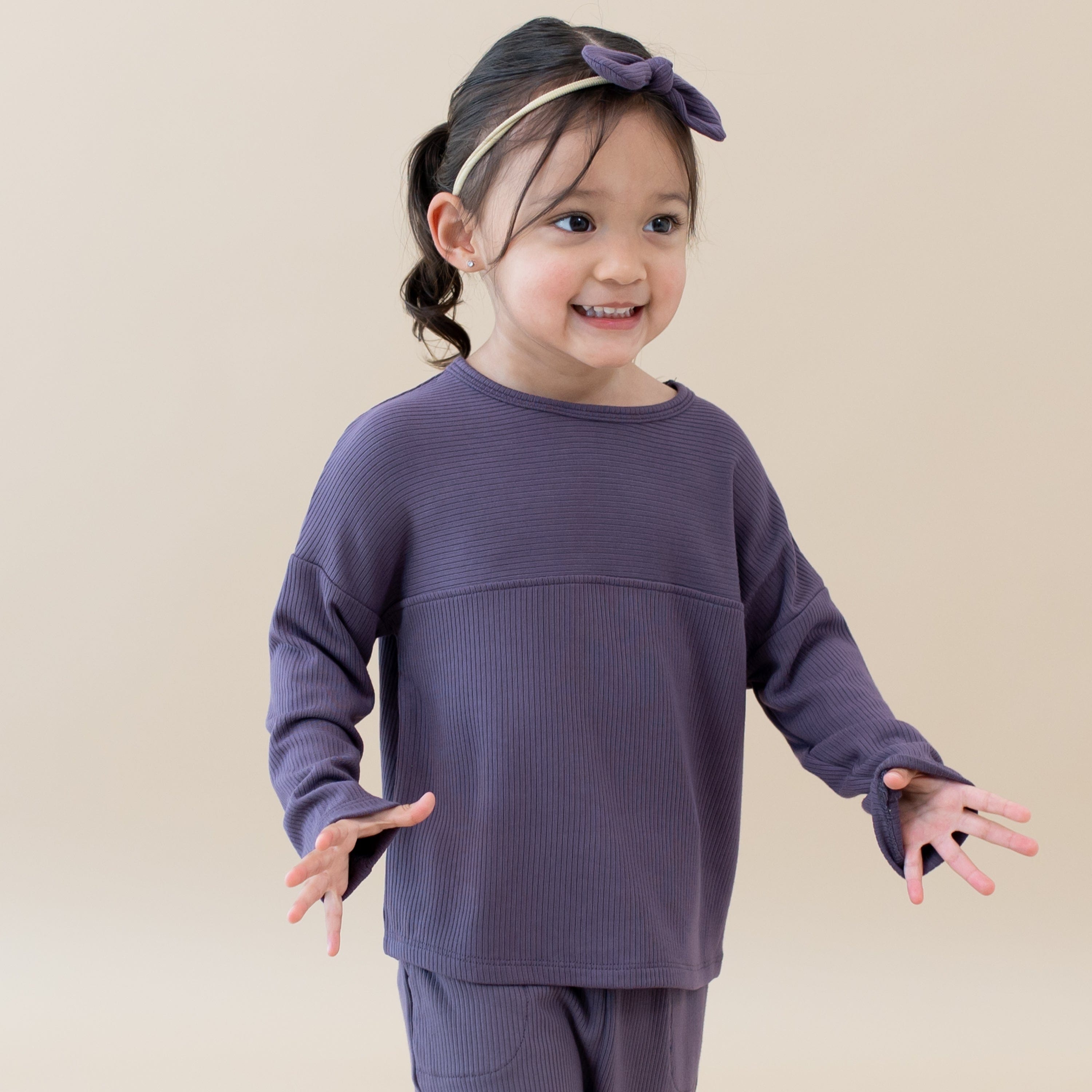 Toddler wearing Kyte Baby Ribbed Drop Shoulder Top in Currant