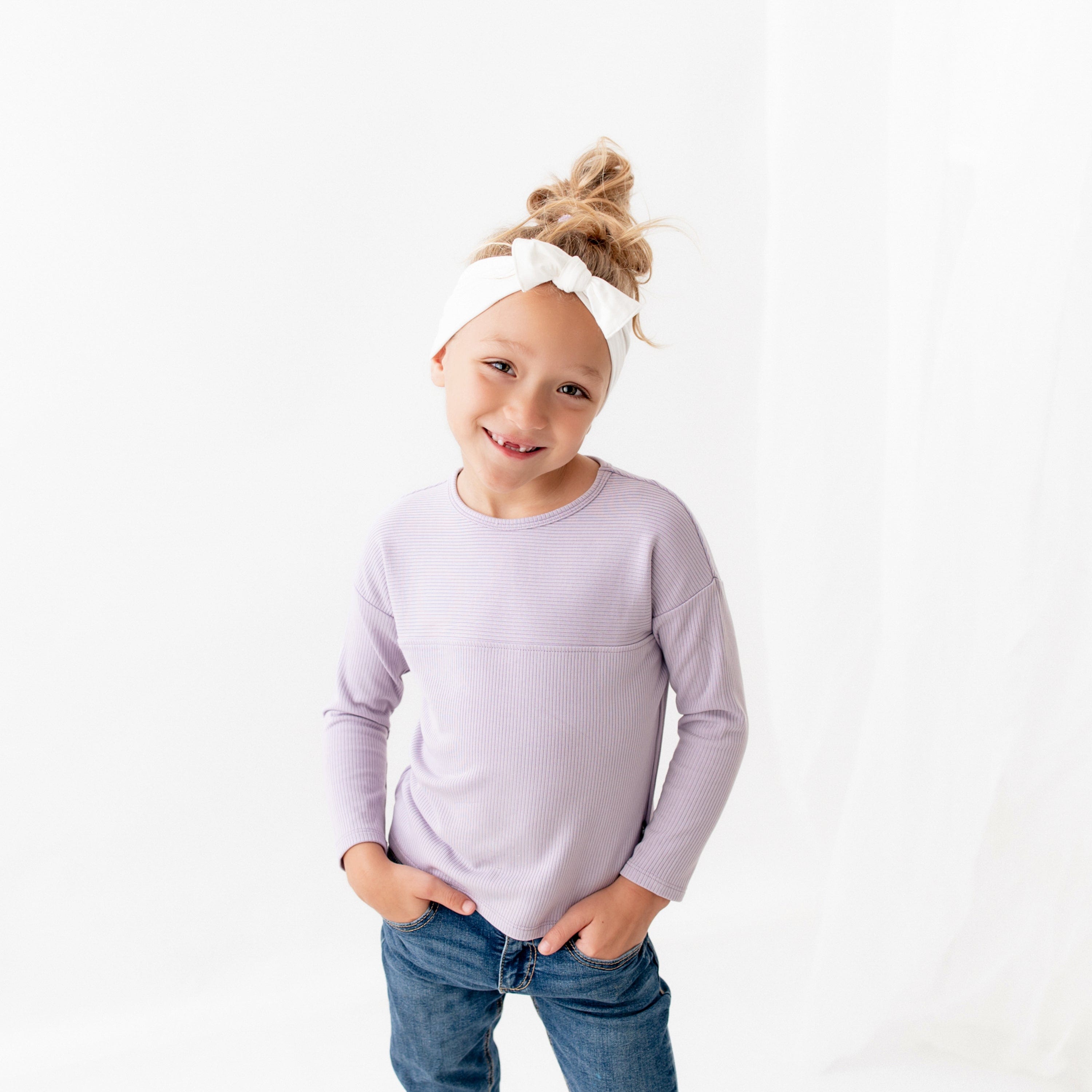 Child wearing Kyte Baby Top with Drop Shoulder and Curved Hem in Taro