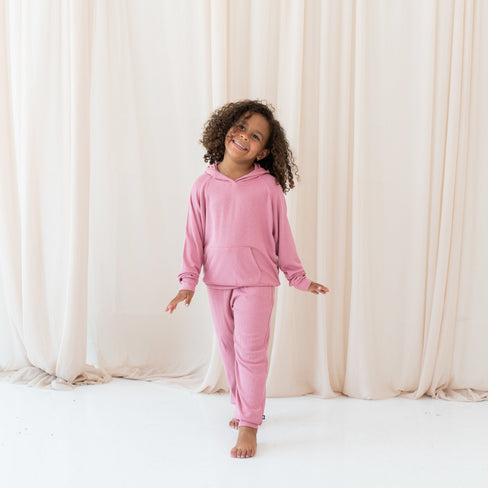 Girl wearing Kyte Baby Ribbed Jogger Pant and Hoodie in Apple Blossom