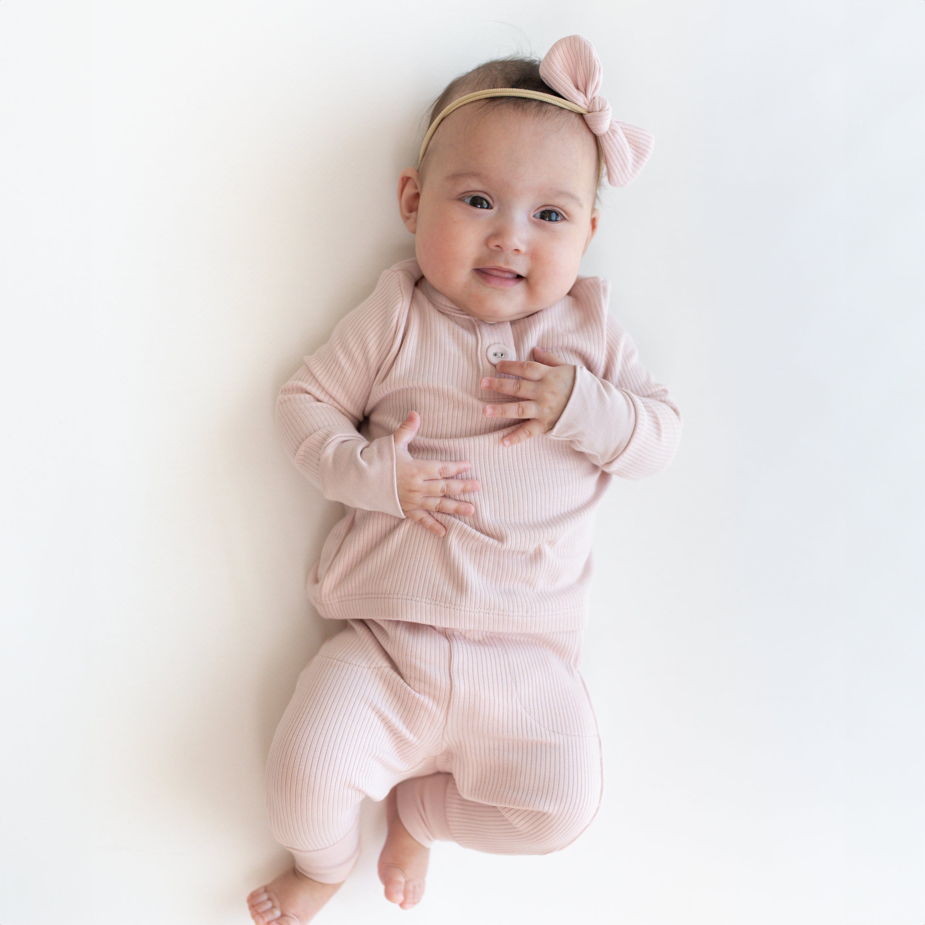 Newborn wearing Kyte Baby Ribbed Infant Henley Set in Blush