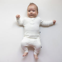Smiling infant wearing two piece Kyte Baby Ribbed Infant Henley Set in Cloud