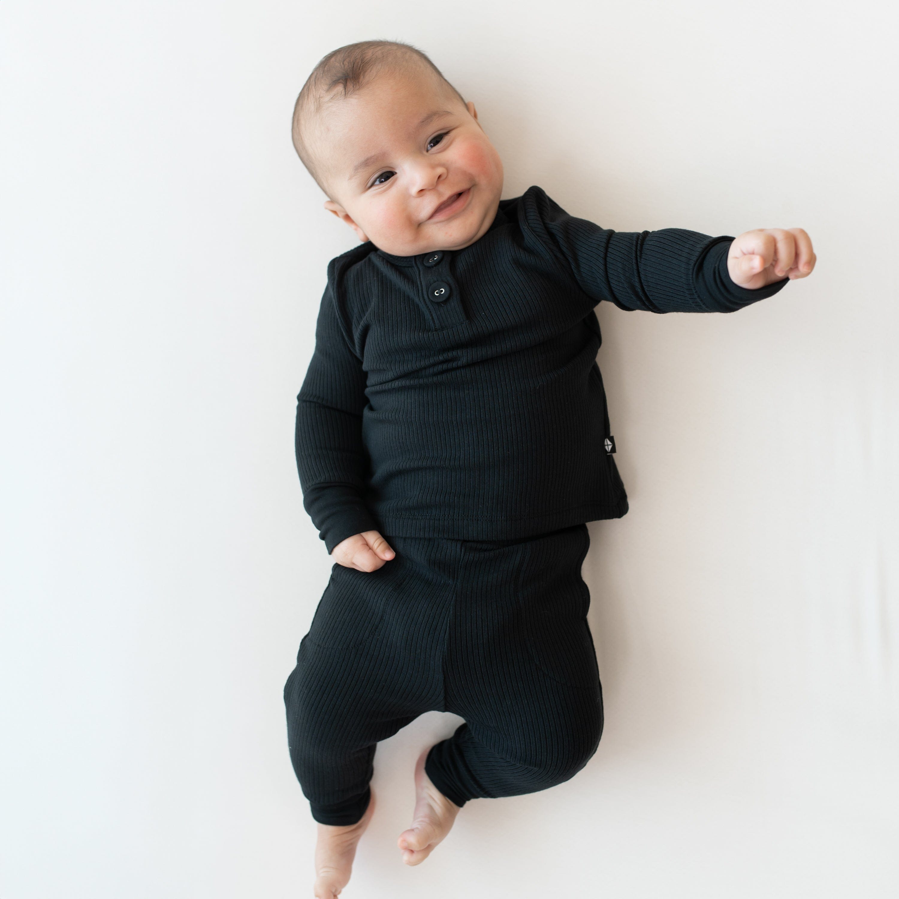 Child wearing Kyte Baby Bamboo Ribbed Infant Henley Set in Midnight black