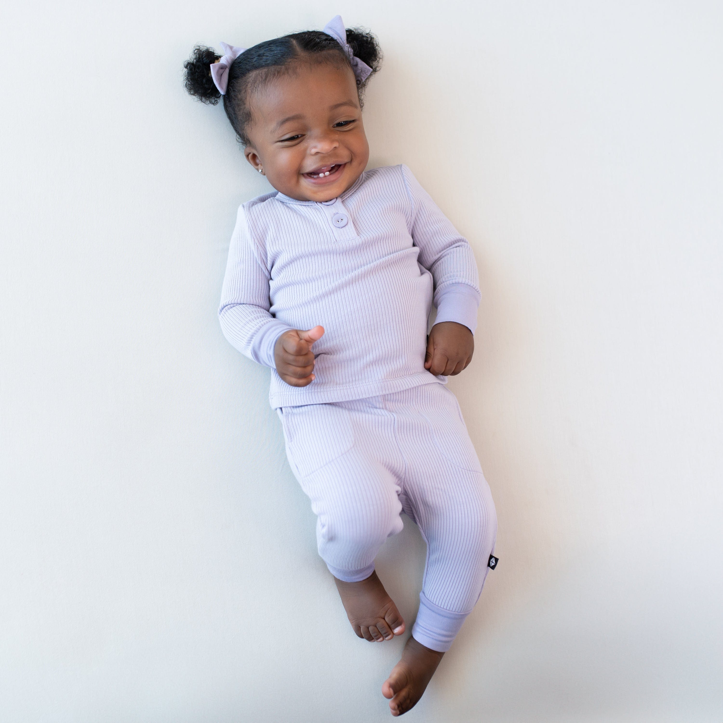 Girl wearing Kyte Baby Ribbed Infant Henley Set in Taro