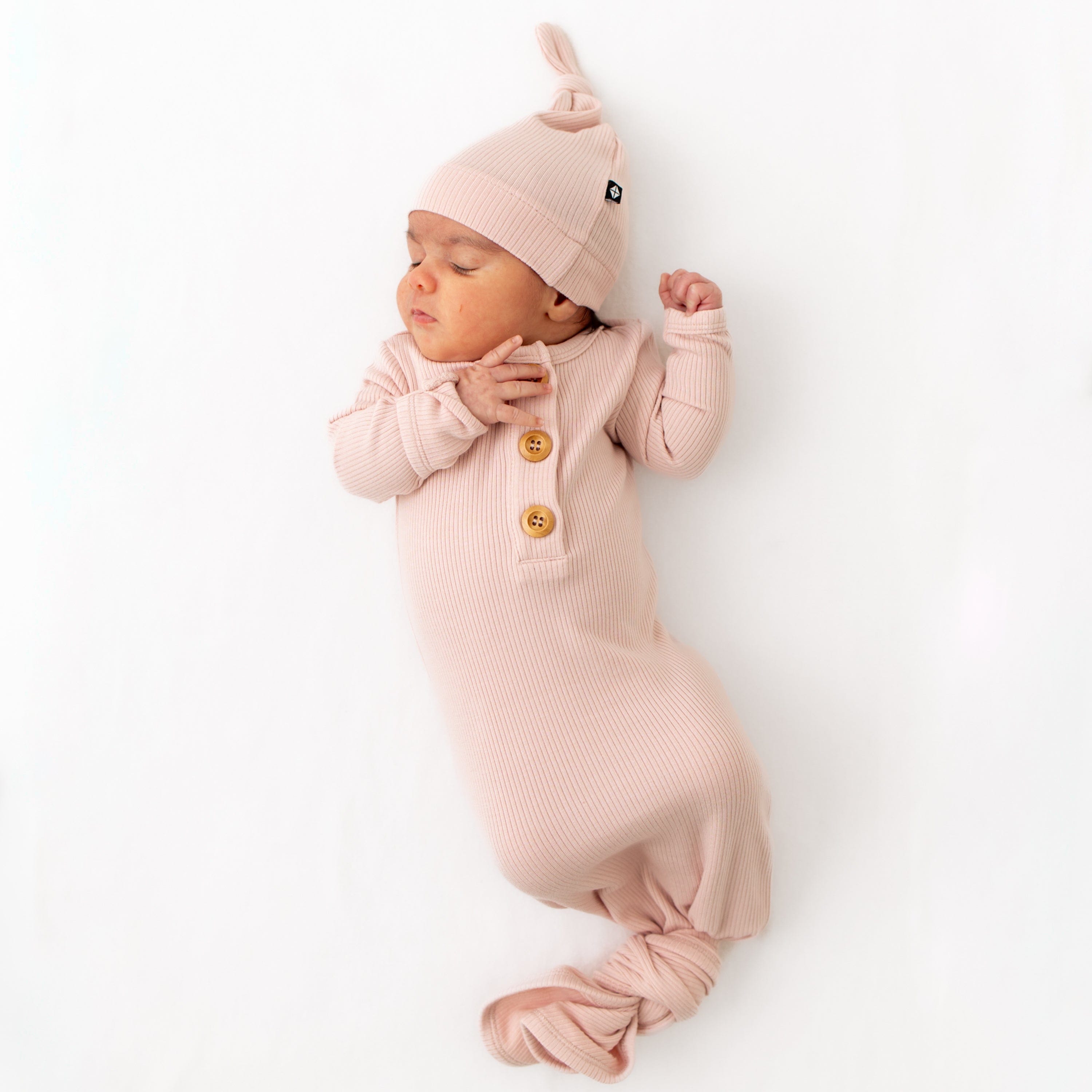 Newborn wearing Kyte Baby bamboo Ribbed Knotted Gown with Hat Set in Blush
