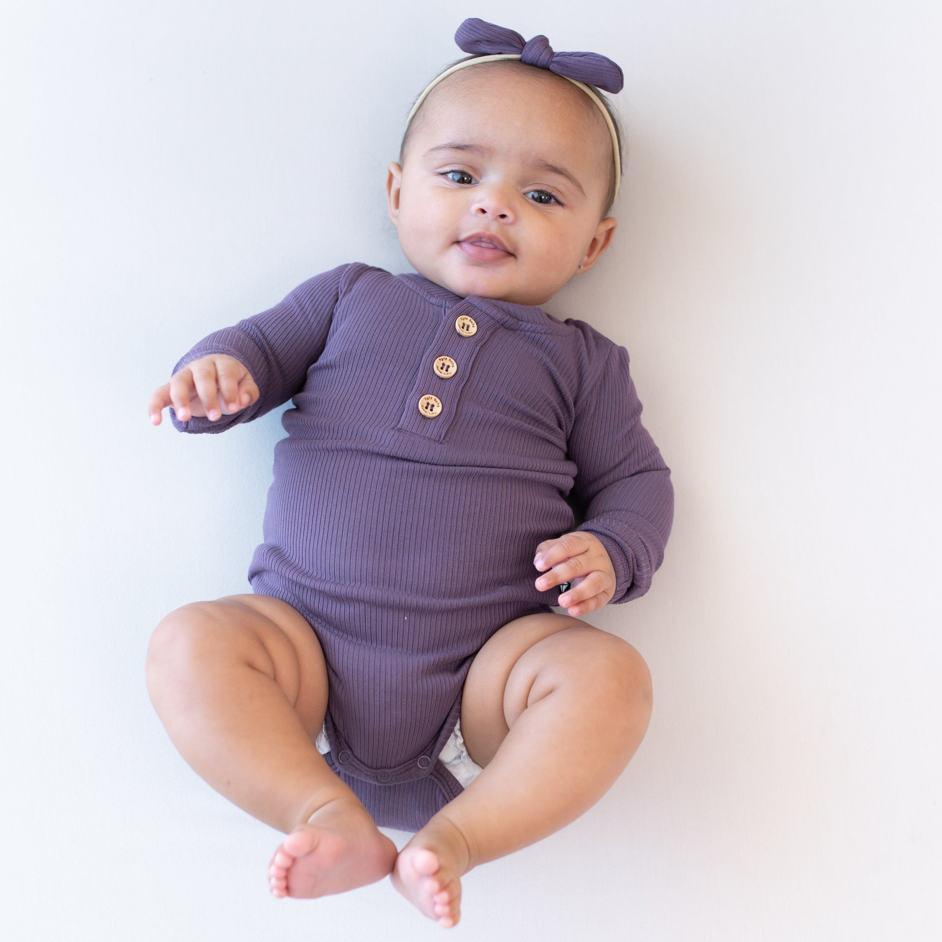 Kyte Baby Ribbed Long Sleeve Henley Bodysuit Ribbed Long Sleeve Henley Bodysuit in Currant