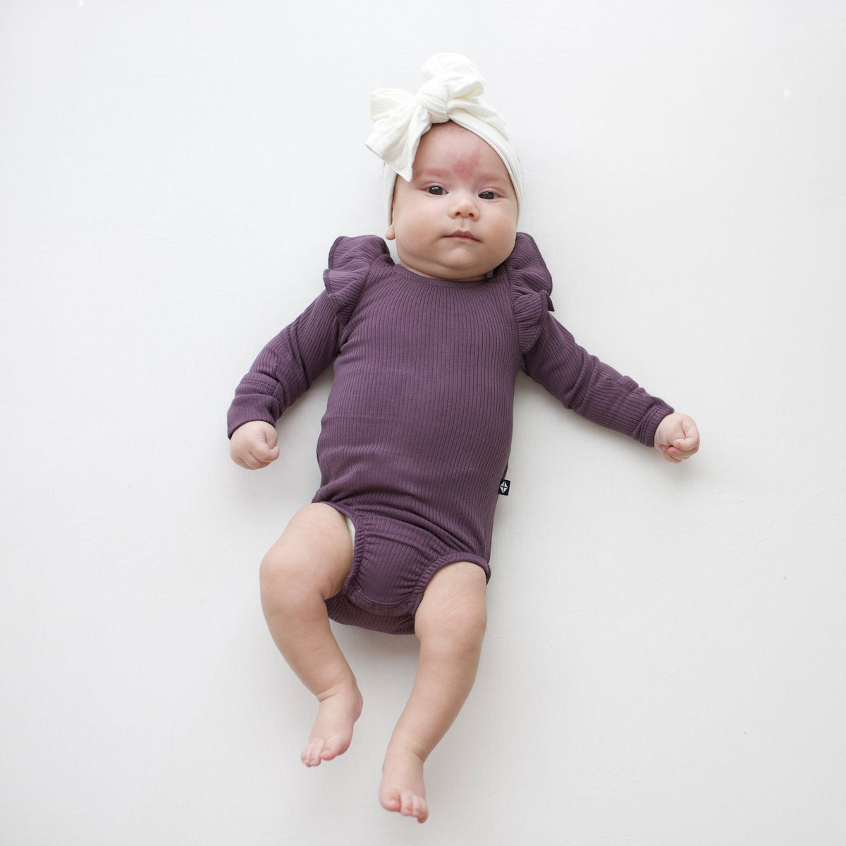 Kyte Baby Ribbed Long Sleeve Ruffle Bodysuit Ribbed Long Sleeve Ruffle Leotard in Currant