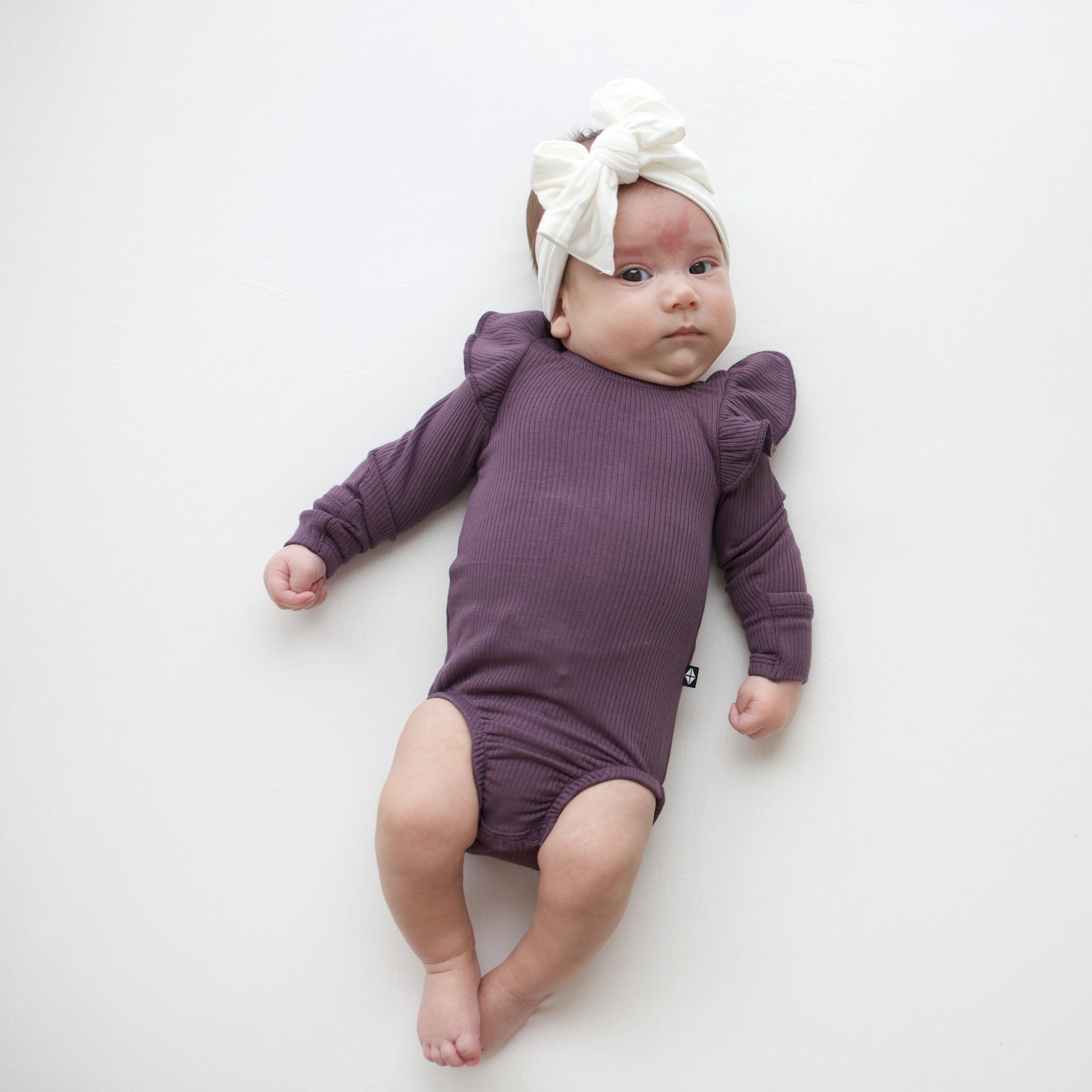 Kyte Baby Ribbed Long Sleeve Ruffle Bodysuit Ribbed Long Sleeve Ruffle Leotard in Currant