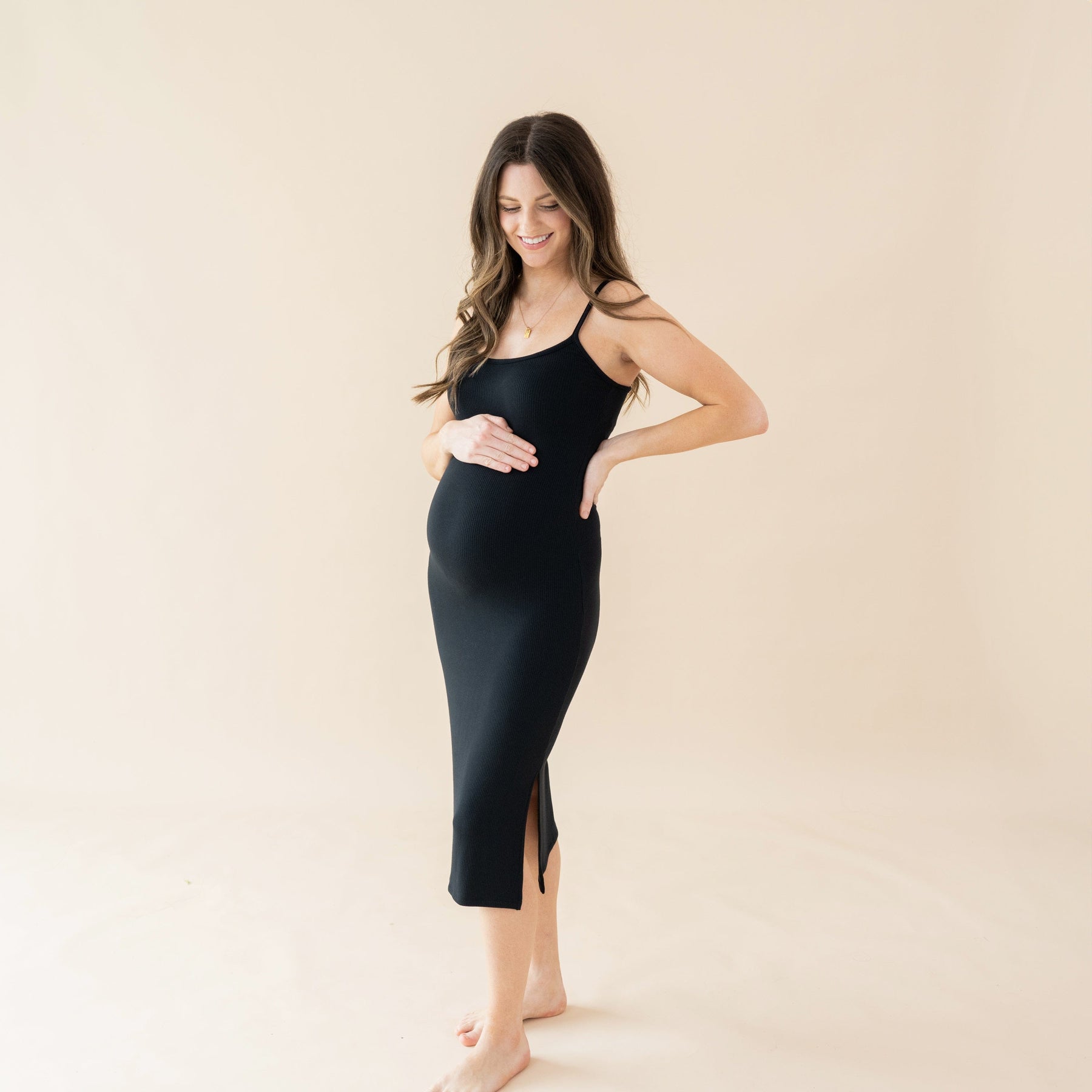 Woman wearing Kyte Baby Ribbed Maternity Cami Dress in Midnight