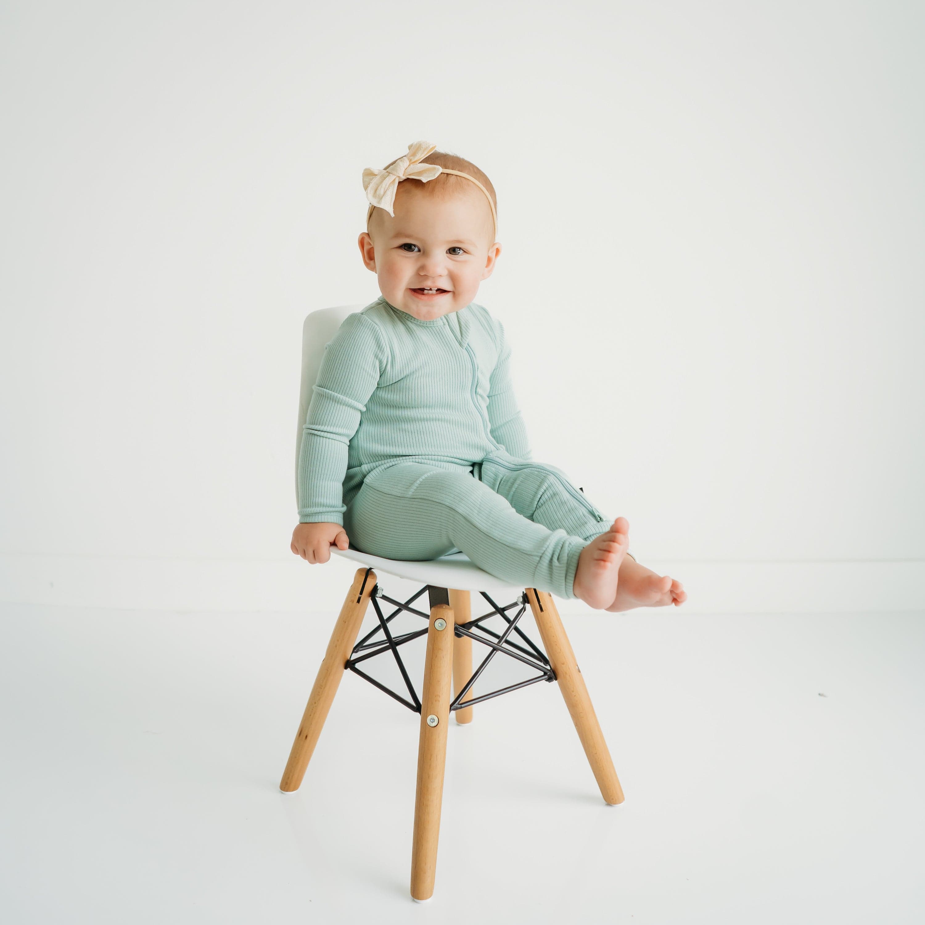 Child wearing Kyte Baby bamboo Ribbed Zippered Romper in Sage