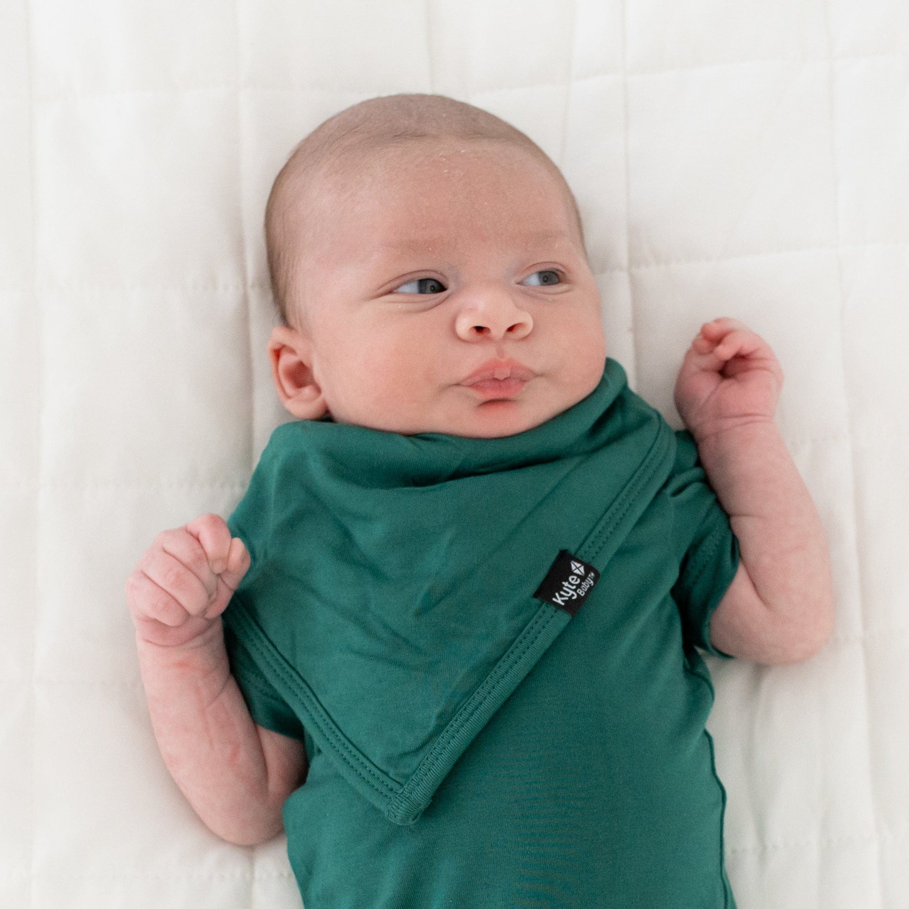 Infant wearing Kyte Baby short sleeve Bodysuit in Emerald
