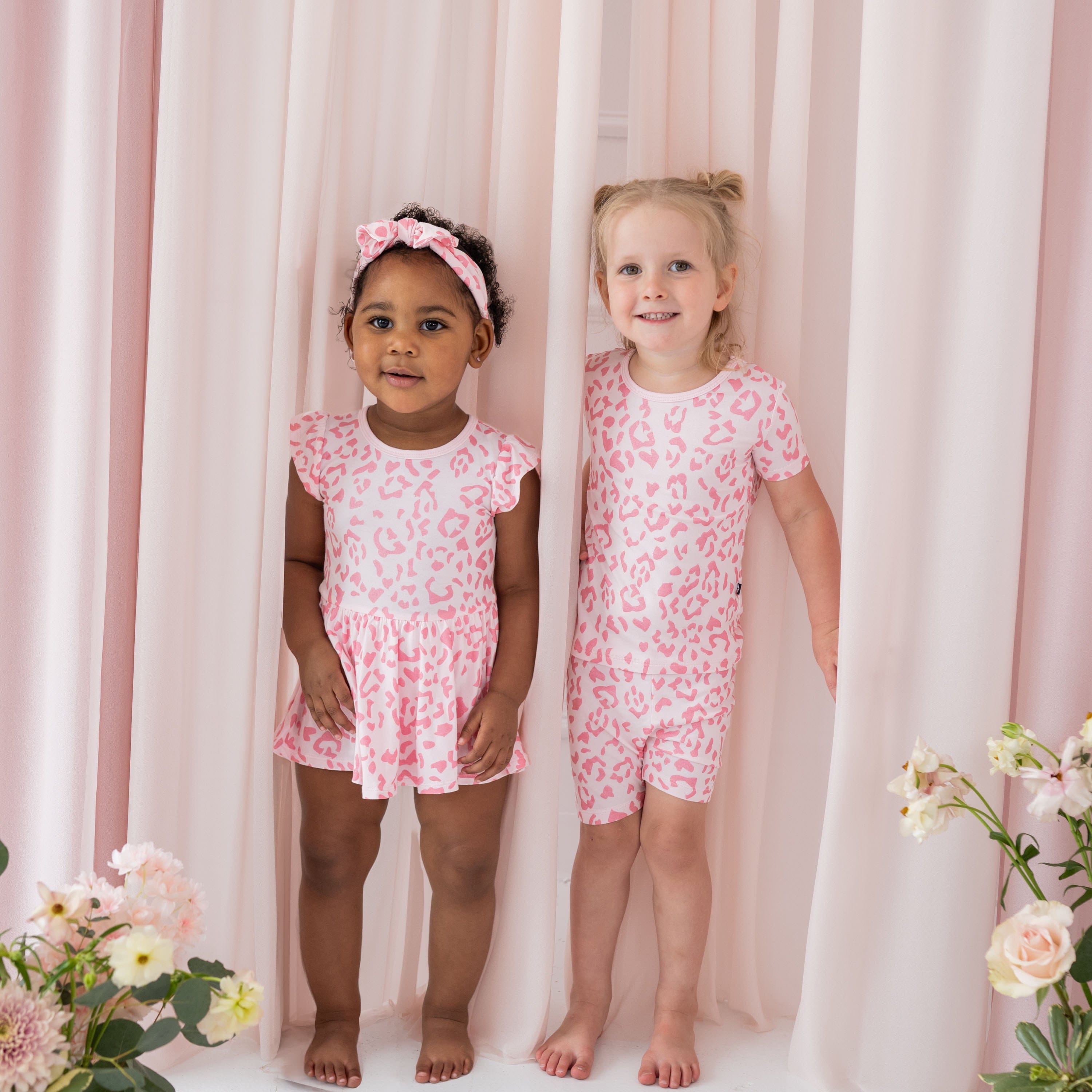 Children wearing Kyte Baby bamboo clothing in Sakura Leopard