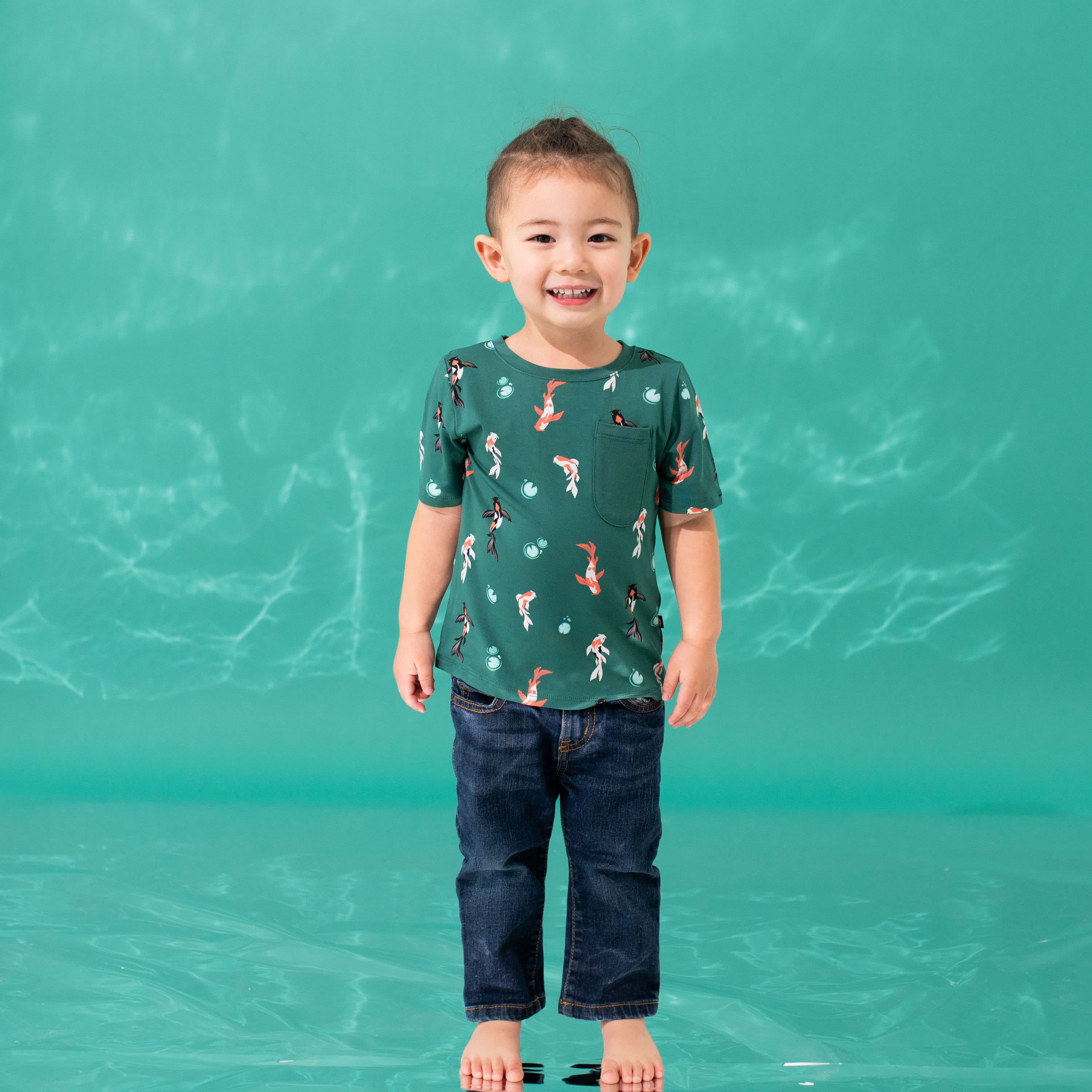 Child wearing Kyte Baby Toddler Crew Neck Tee with chest pocket in Koi