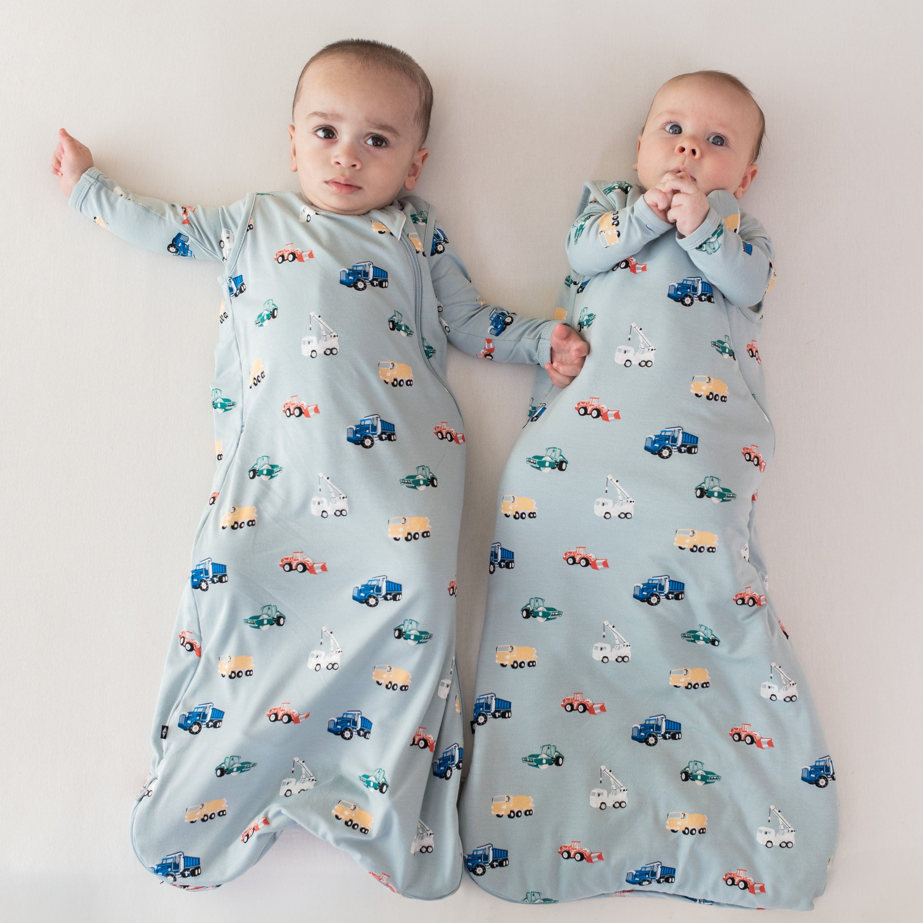 Babies wearing Kyte Baby sleep bags TOG 0.5 with construction pattern