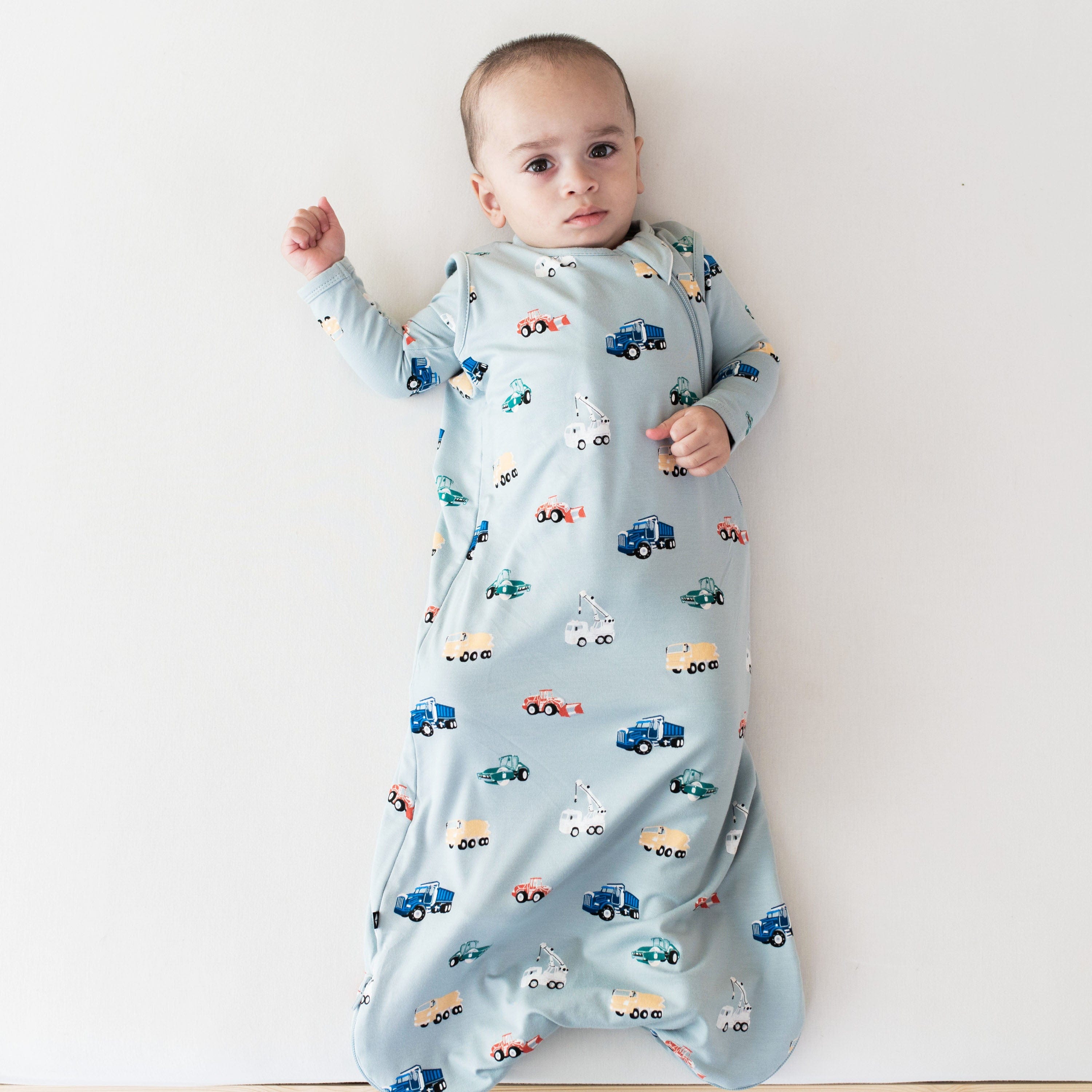 Infant wearing Kyte Baby Sleep Bag in Construction 0.5