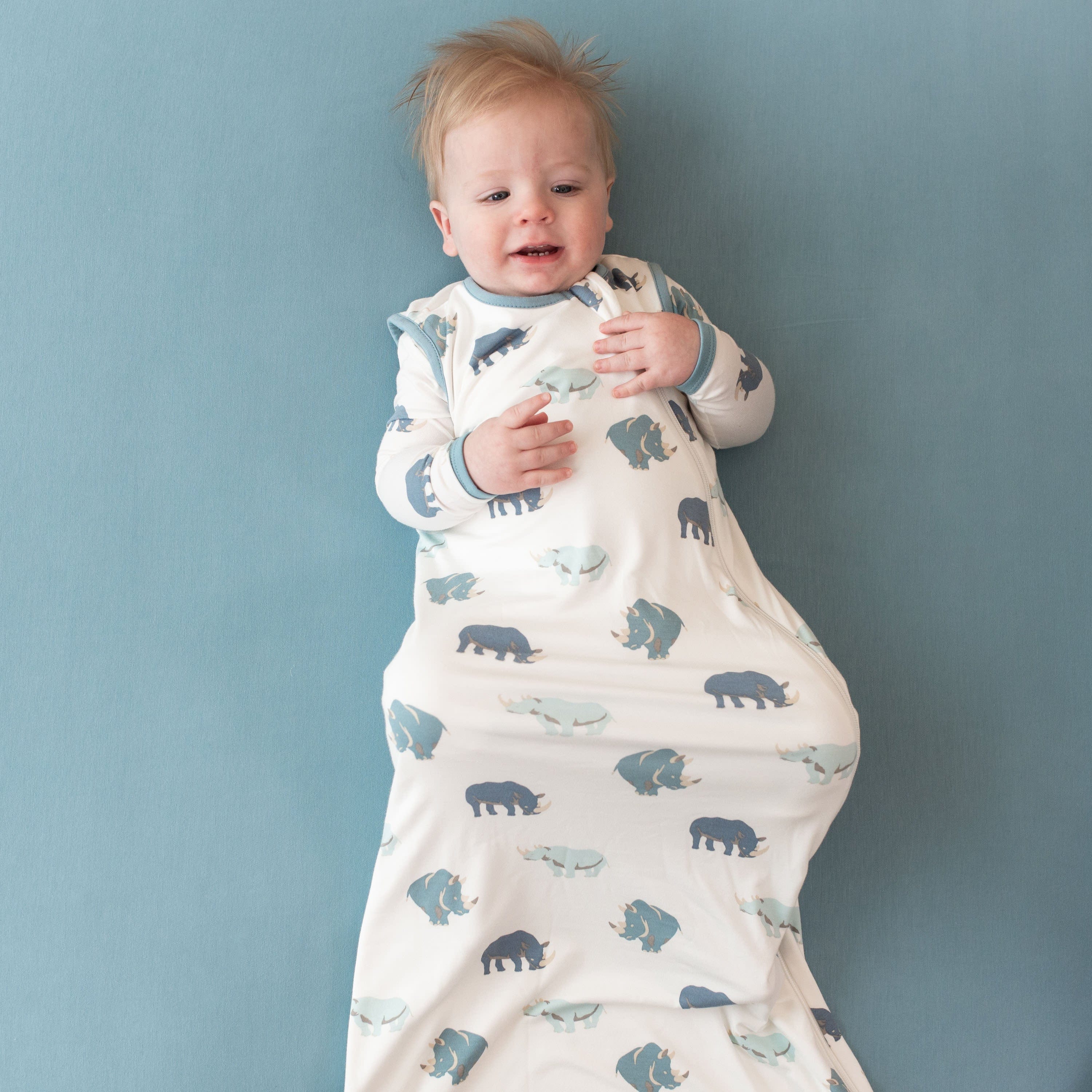 Infant wearing Kyte Baby Sleep Bag in Rhino 0.5