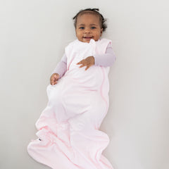 Infant wearing Kyte Baby Sleep Bag in Sakura 0.5